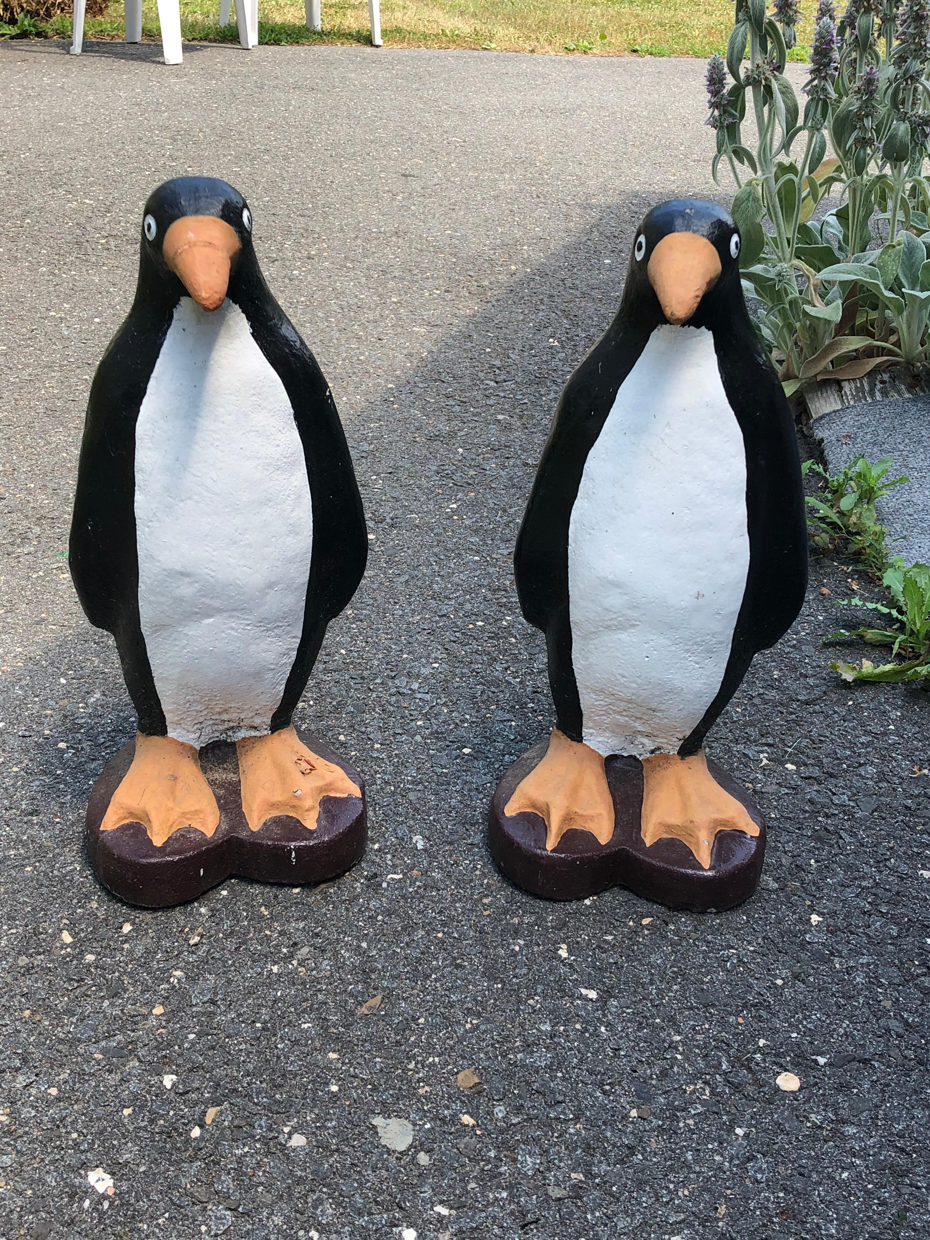 An adorable pair of vintage cast cement garden or patio adornments that are black, white and yellow enchanting penguins. Original paint and heart shaped bases.