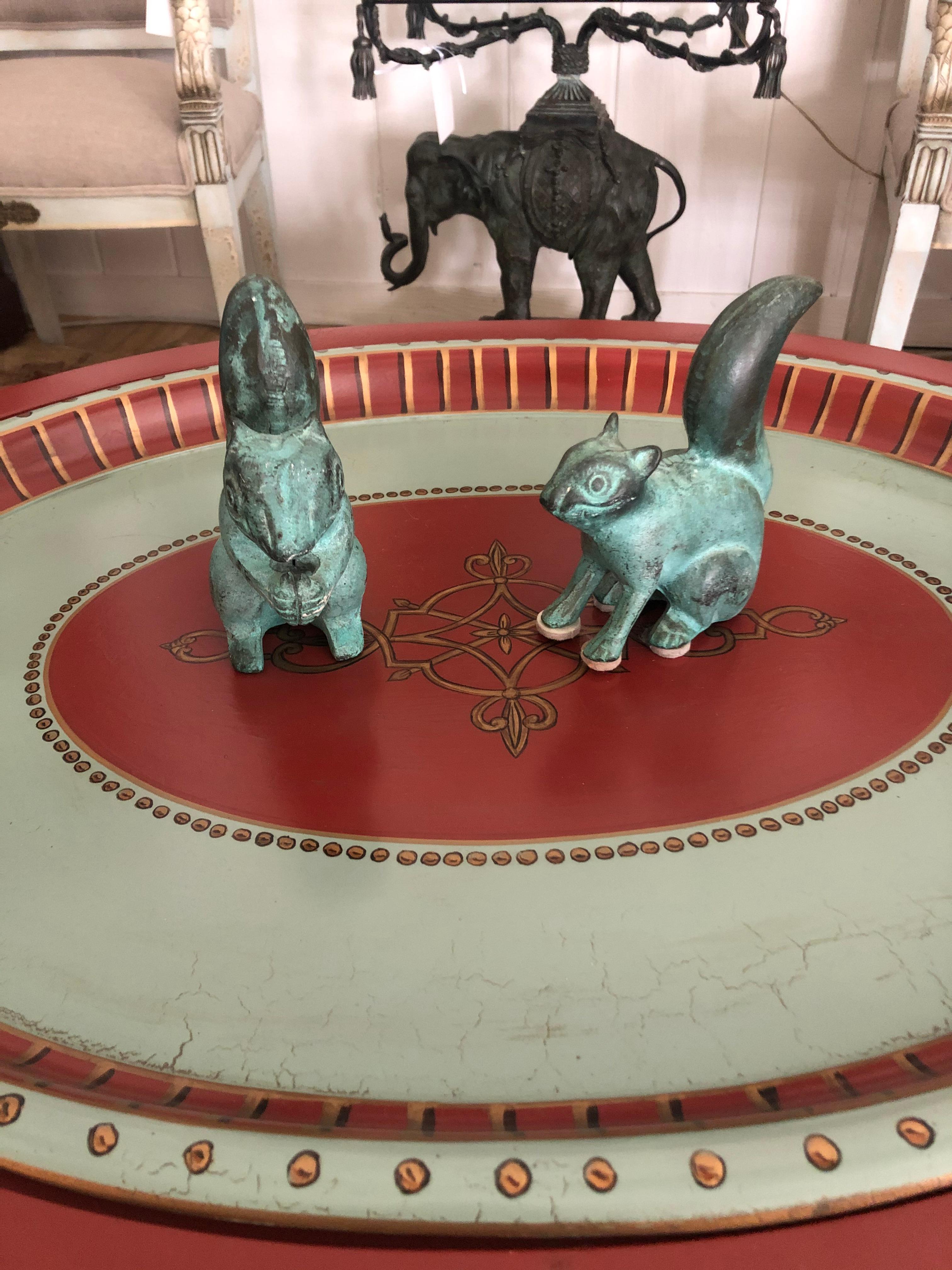 Enchanting pair of cast iron squirrel tabletop sculptures in a striking shade of turquoise.