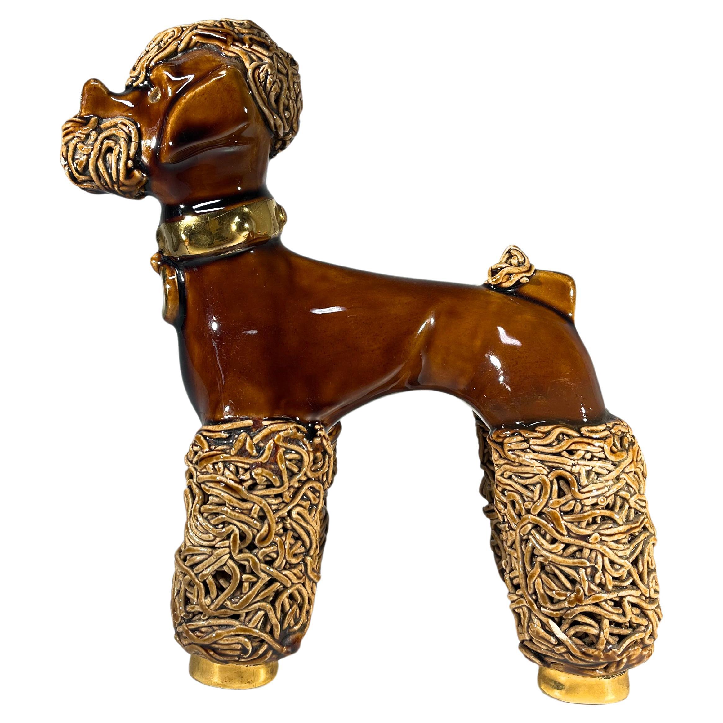 Sporting a 'Dutch Cut' to his coat, this adorable ceramic poodle stands tall and proud
Collar and feet are gilded, the glaze is a delicious toffee caramel colour and the eyes are pink glass.
Understood to have resided on a lady's nightstand
Circa
