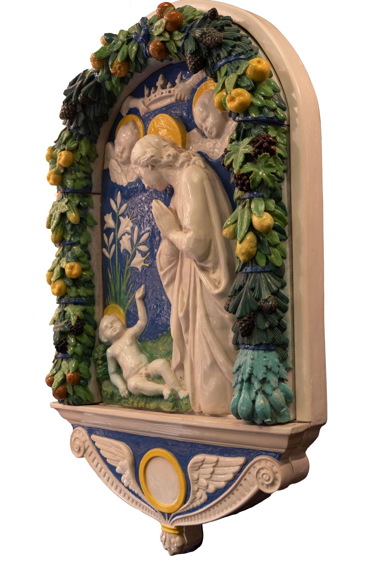 After Andrea della Robbia (Florentin, 1435-1525) Adoration of the Christ Child (circa 1890) A large terracotta sculpture of Mary and the Christ Child with a heavy wreath of woven fruit and leaves, made during the last quarter of the 19nth century.