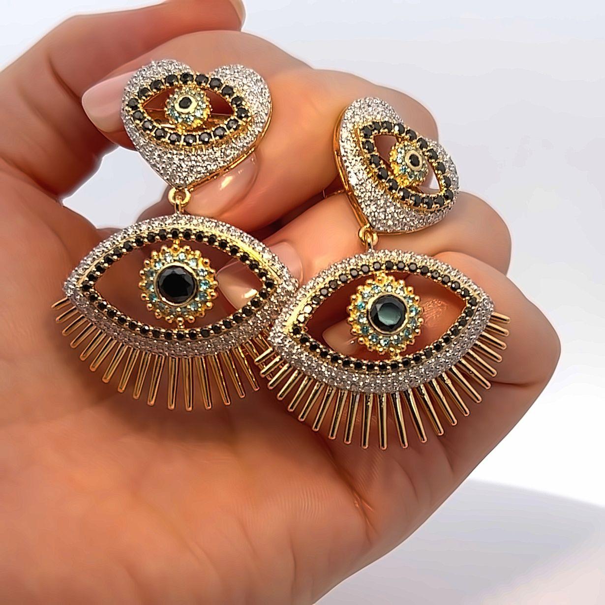 Introducing our captivating Evil Eye Earrings, a contemporary and stylish reinterpretation of a timeless symbol of protection. These enchanting earrings are meticulously handcrafted with the utmost precision and care, designed not only to elevate