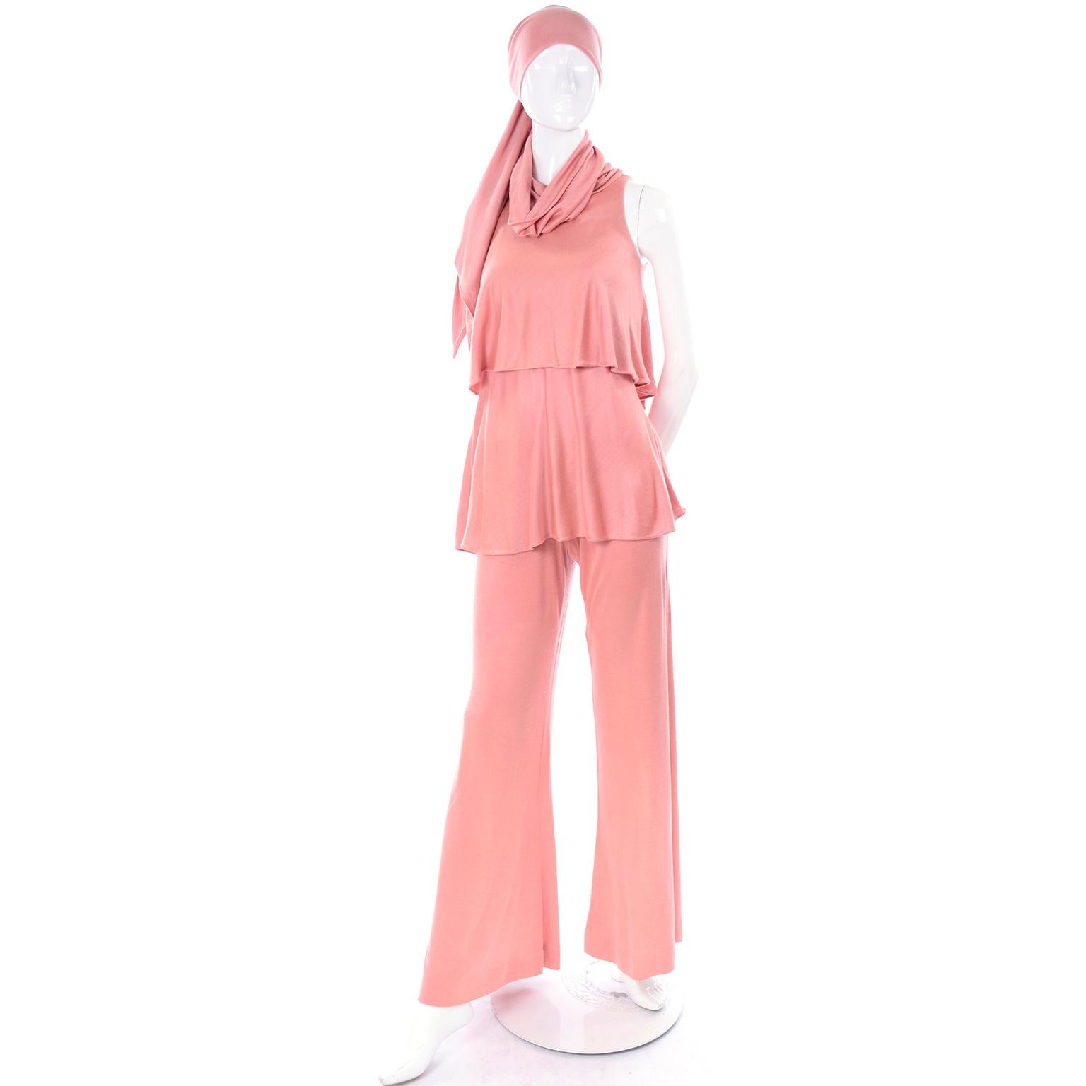 This is a glamorous vintage Adri coral pink jersey outfit, with a sleeveless turtleneck top, wide leg stretch pants and matching sash!  The designer was known for her free flowing garments made of Italian imported fabrics. The turtleneck has enough