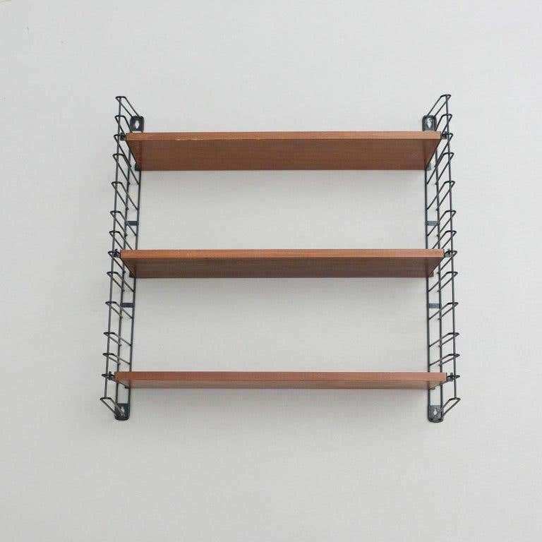 Modular shelve designed by Adriaan D. Dekker in 1958.
Manufactured by Tomado in The Netherlands.

It possible to fit multiple shelves together, thus achieving a personalized/modular shelving system.

In good original condition with minor wear