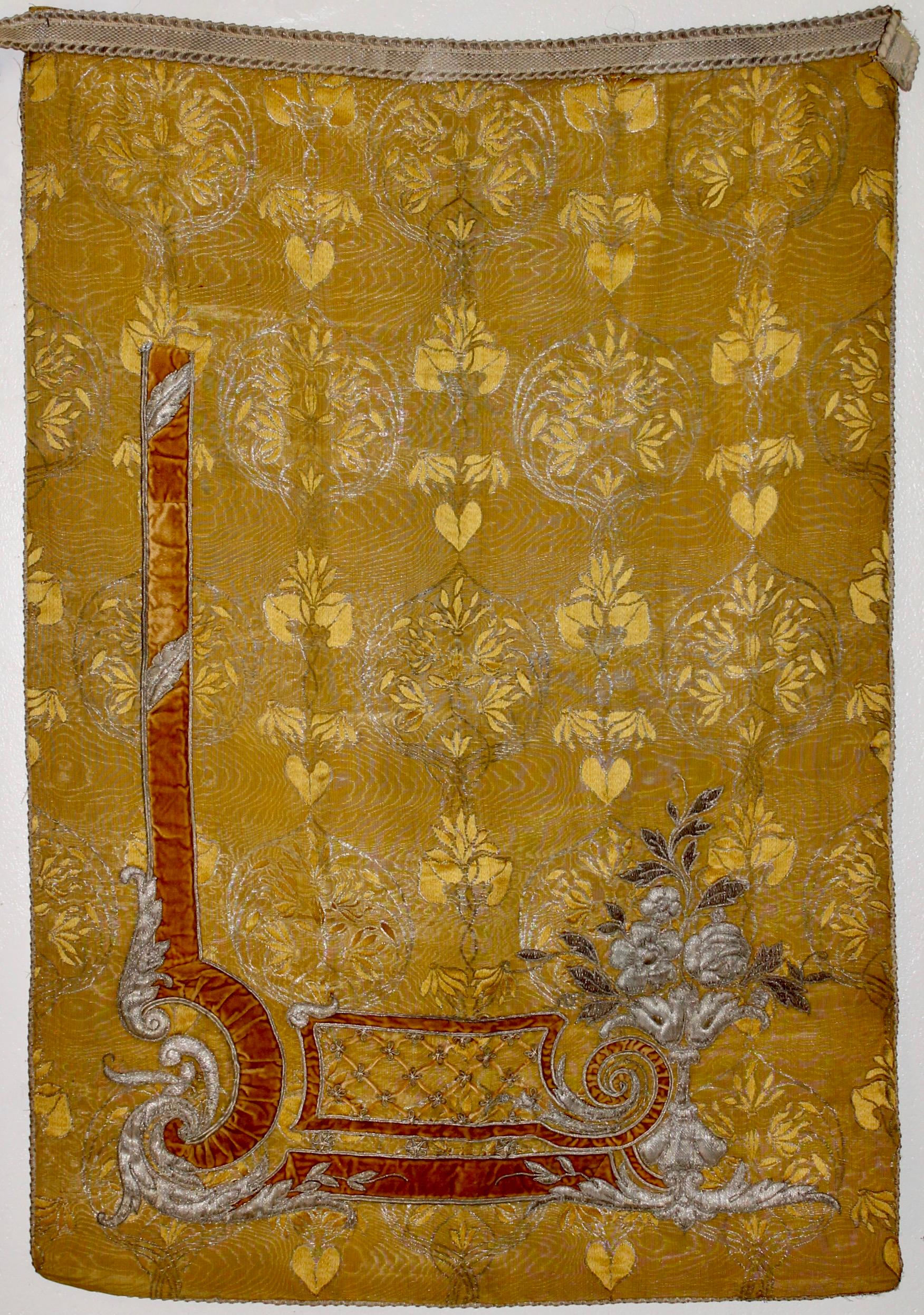 Intricately embroidered with 'turn of century' motifs in silk and velvet on golden yellow moire silk. 