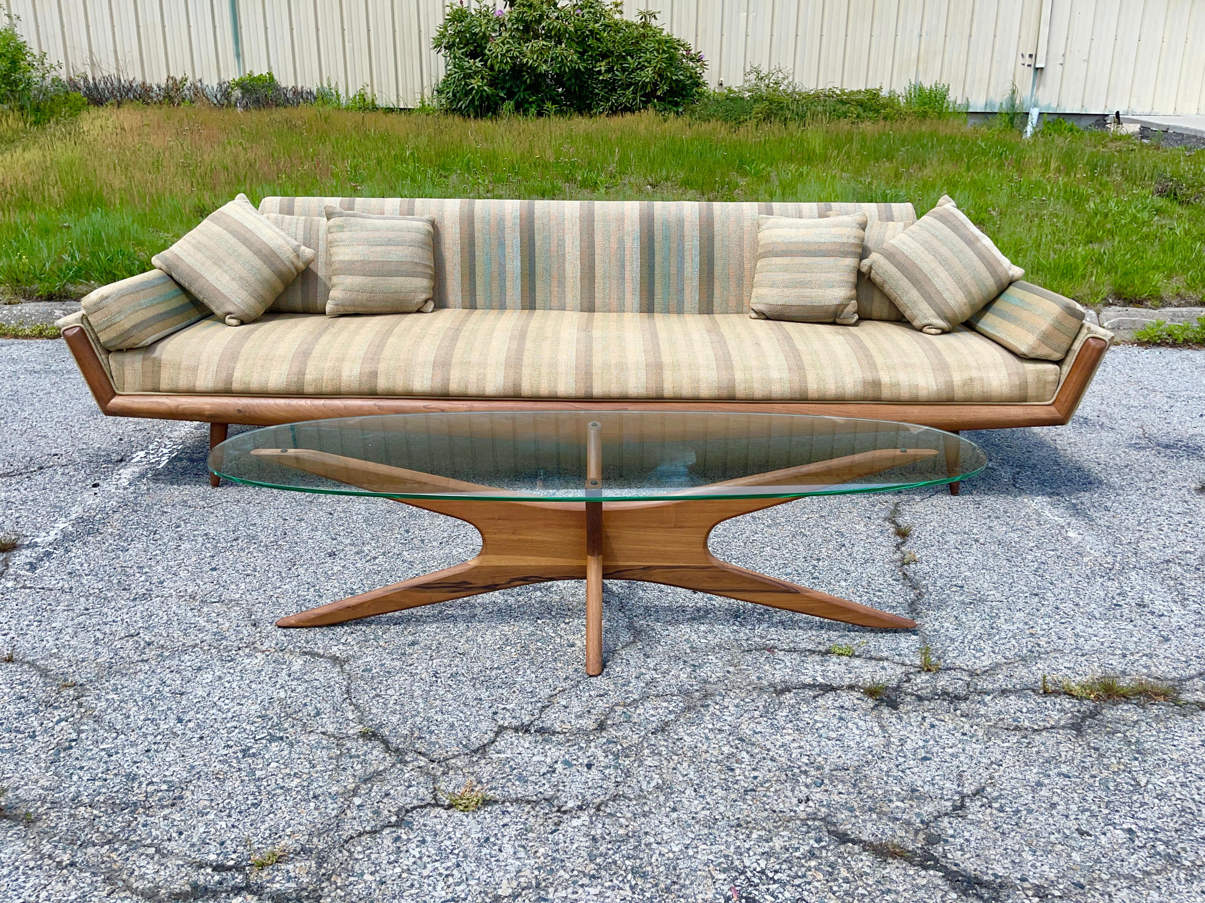 Original 1960’s sculptural organic “Jacks”cocktail table in beautifully figured solid walnut designed by Adrian Pearsall for Craft Associates topped with elongated elliptical oval glass. A mid-century modern design classic from one of America’s most