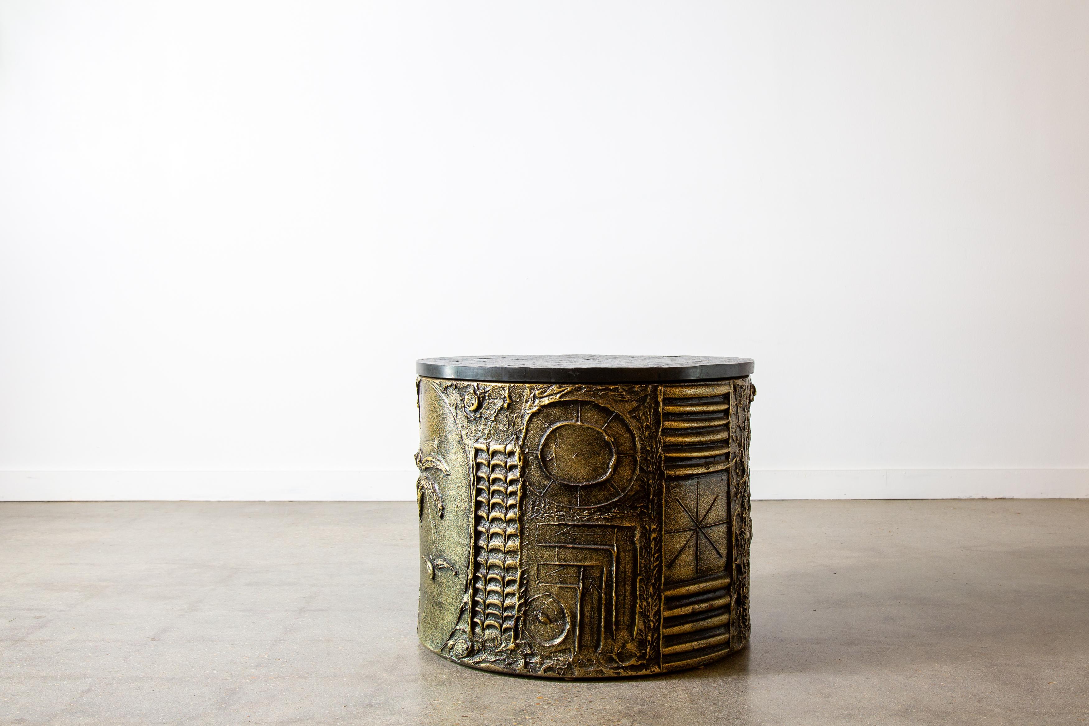 A 1960s large occasional drum table designed by Adrian Pearsall for Craft Associates. In the style of Paul Evans Goop series, Adrian Pearsall offered a built up resin relief in painted bronze and darker tones.  Patterns of sunbursts, palms, and