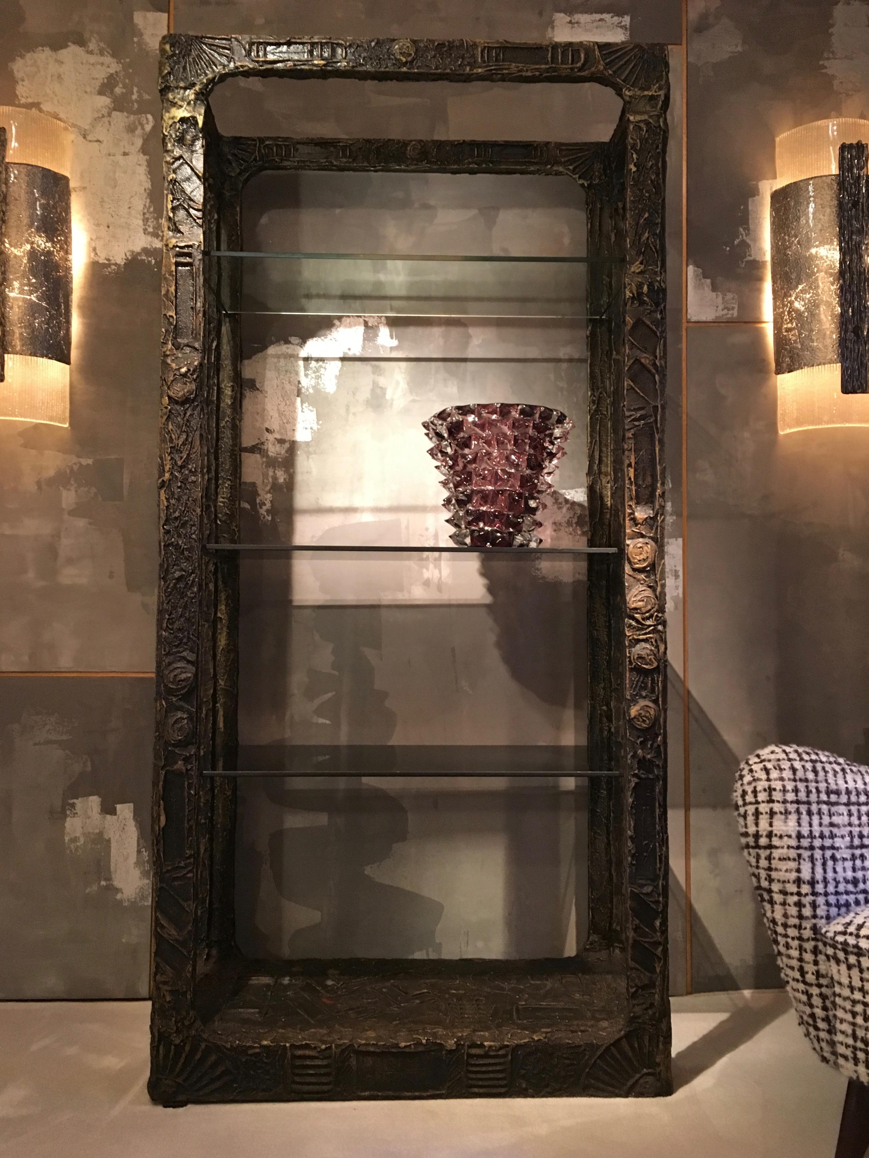 What can be said about this ètagère by Adrian Pearsall? Simple in its form with open sides and three glass shelves, the beauty lies in the design of the frame. The close-up photos show the detail that he put into the piece. Looking like cast bronze,