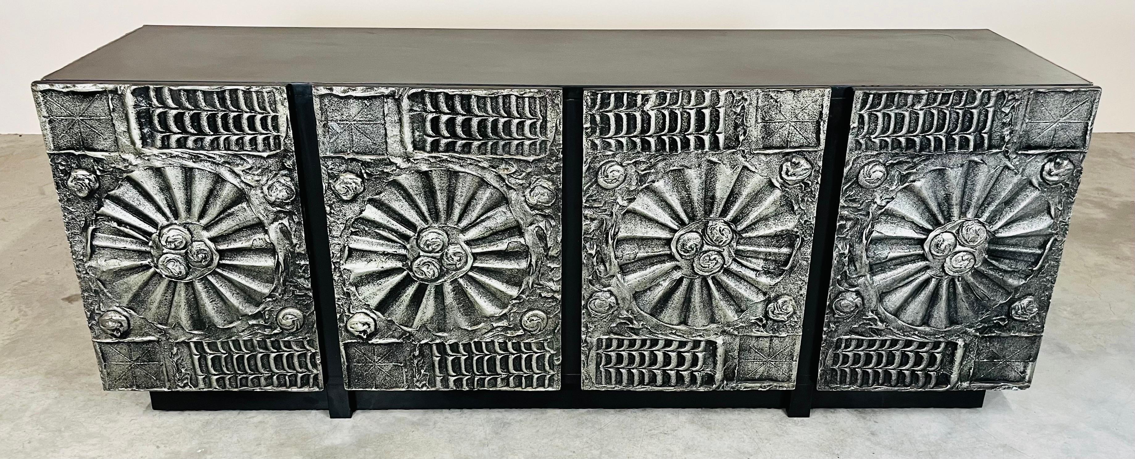 A stunning brutalist credenza designed by Adrian Pearsall in the manner of Paul Evans having 4 doors with a single center top drawer and ample shelf storage. Sculpted resin over wood with bronze color finish. A stunning design and the larger