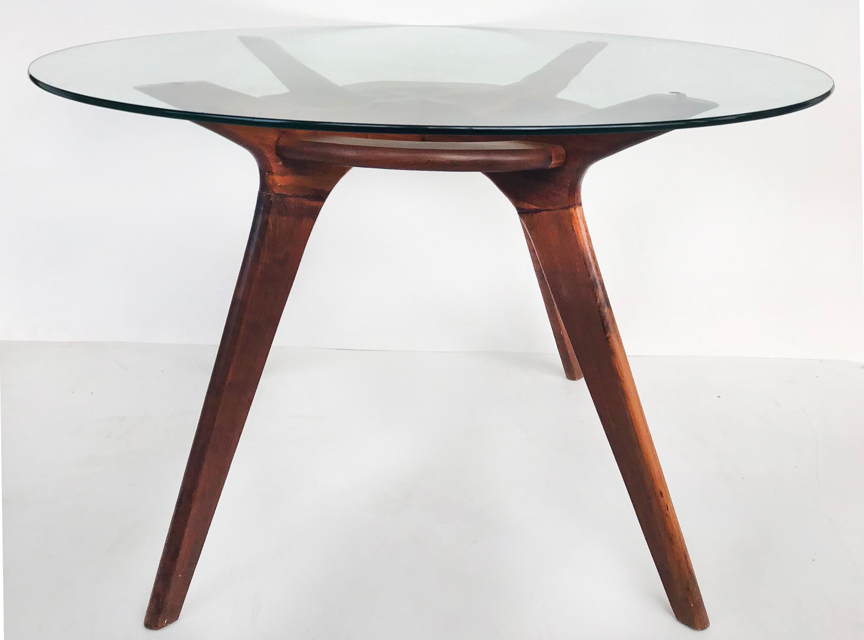 Offered for sale is an Adrian Pearsall glass top center/breakfast table with an oiled walnut base. The base supports a .5