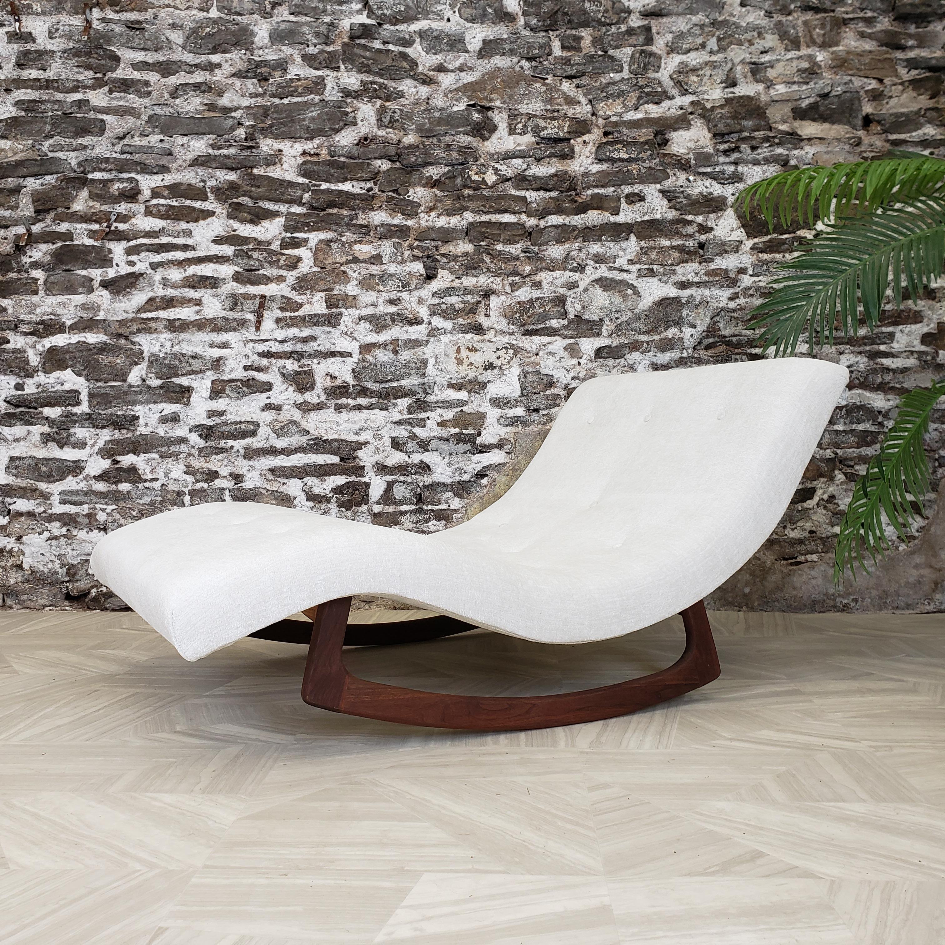 This stylish Adrian Pearsall chaise/rocking lounge chair features a spacious sculpted wave like seat with newly upholstered fabric and completely refinished walnut rockers. This iconic mid-century piece makes an impressive and comfortable addition
