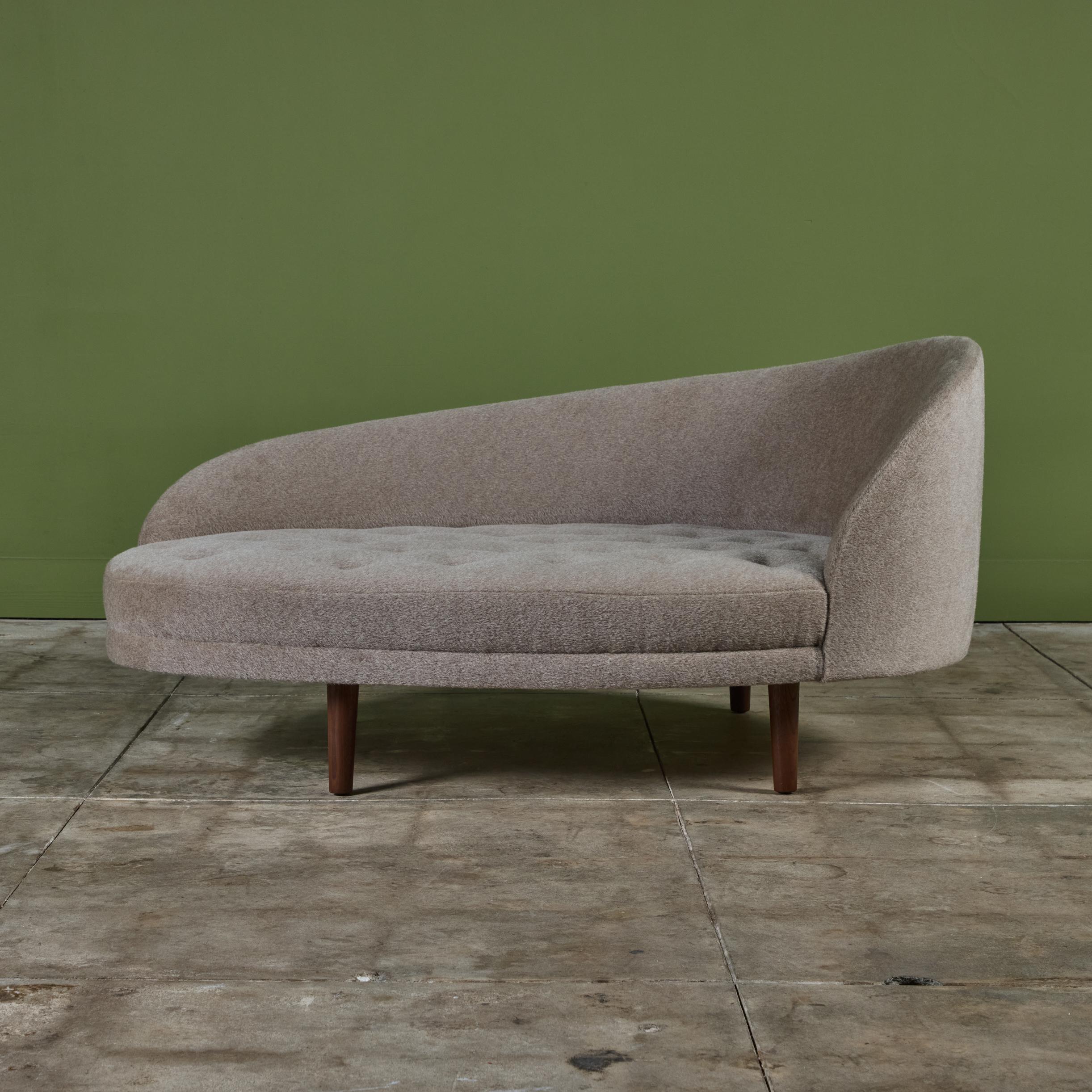 Adrian Pearsall chaise lounge for Craft Associates c.1960s, USA. The lounge features a curved seat back and rounded seat cushion that rests on four tapered walnut legs. The piece has been newly reupholstered in a light beige mohair fabric with