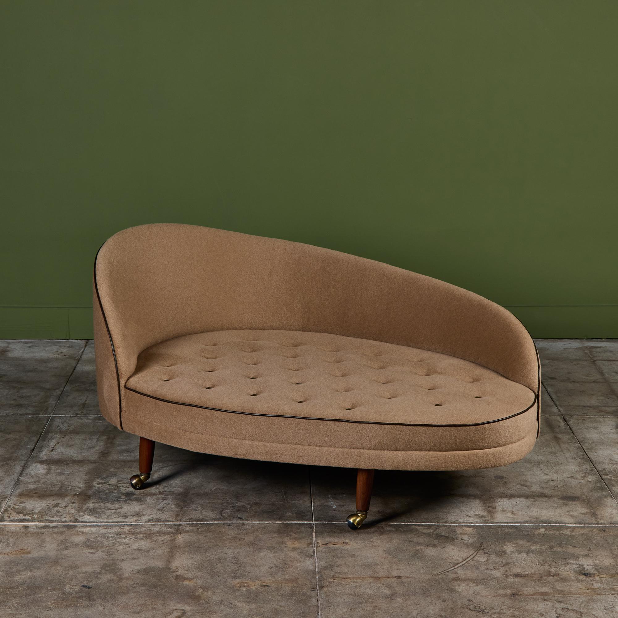 Adrian Pearsall chaise lounge for Craft Associates c.1960s, USA. The lounge features a curved seat back and rounded seat cushion that rests on four tapered walnut legs with casters. The piece has been newly reupholstered in a tan mohair fabric with