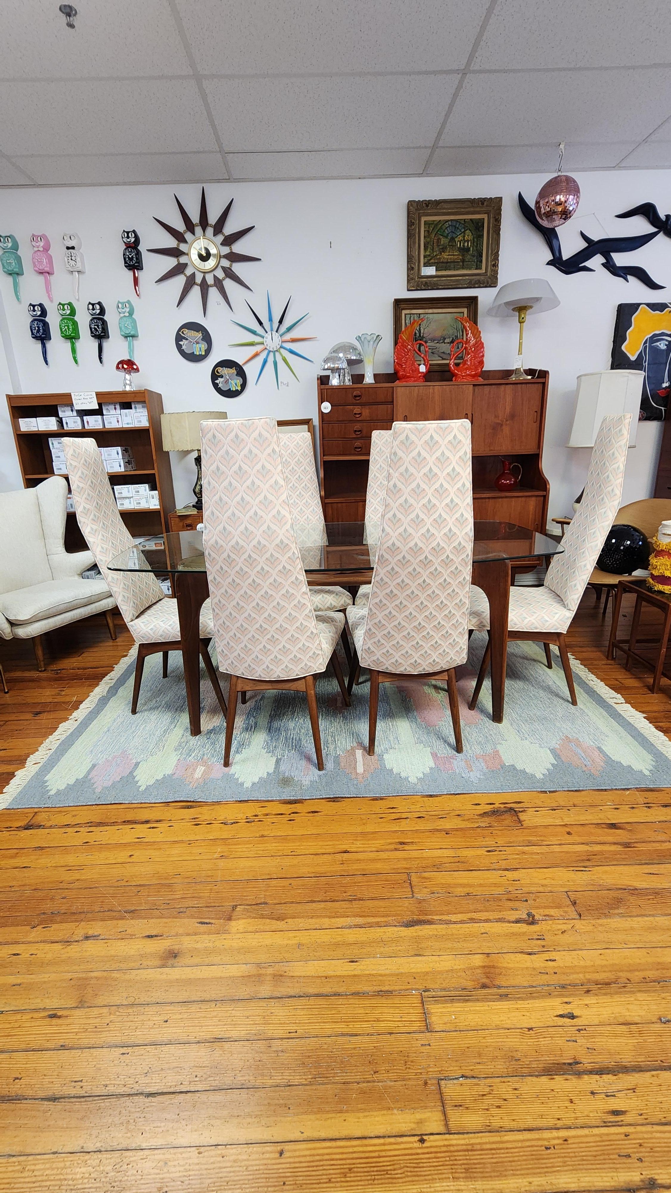 This is an incredible example of one of Adrian Pearsall's most iconic designs, the Compass Table and coordinating chairs. 
The base of the table is hand crafted from gorgeous American walnut. The carved turns and corners and unique joinery exemplify