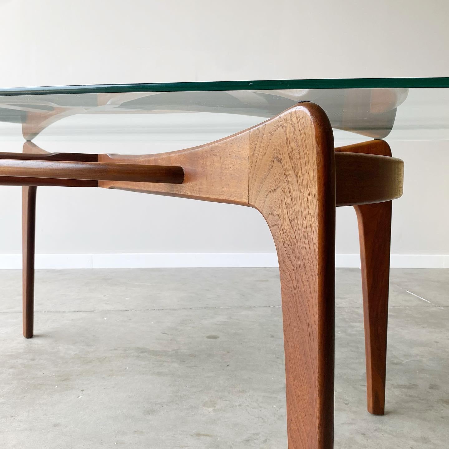 An incredible sculpted walnut base with original glass top. Classic mid century styling from Adrian Pearsall.

Measures 71” by 38.5”, 29” high.  

surface scratches to glass and one small chip.  