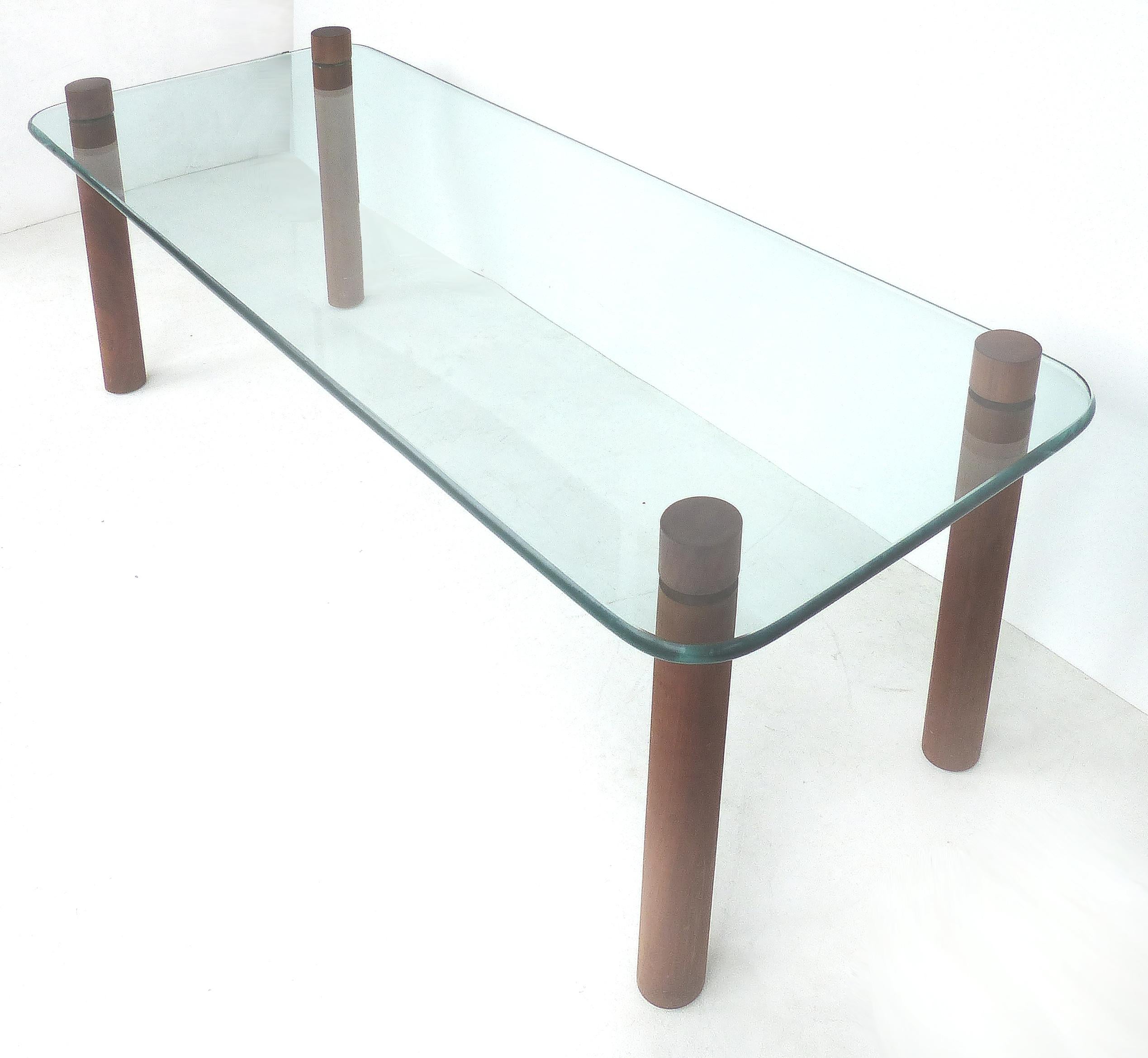 Adrian Pearsall Craft Associates glass coffee table with wood, circa 1960s

Offered for sale is an Adrian Pearsall glass and wood coffee table circa 1960s. The glass top is supported by woo legs that intersect the top. The table was produced by