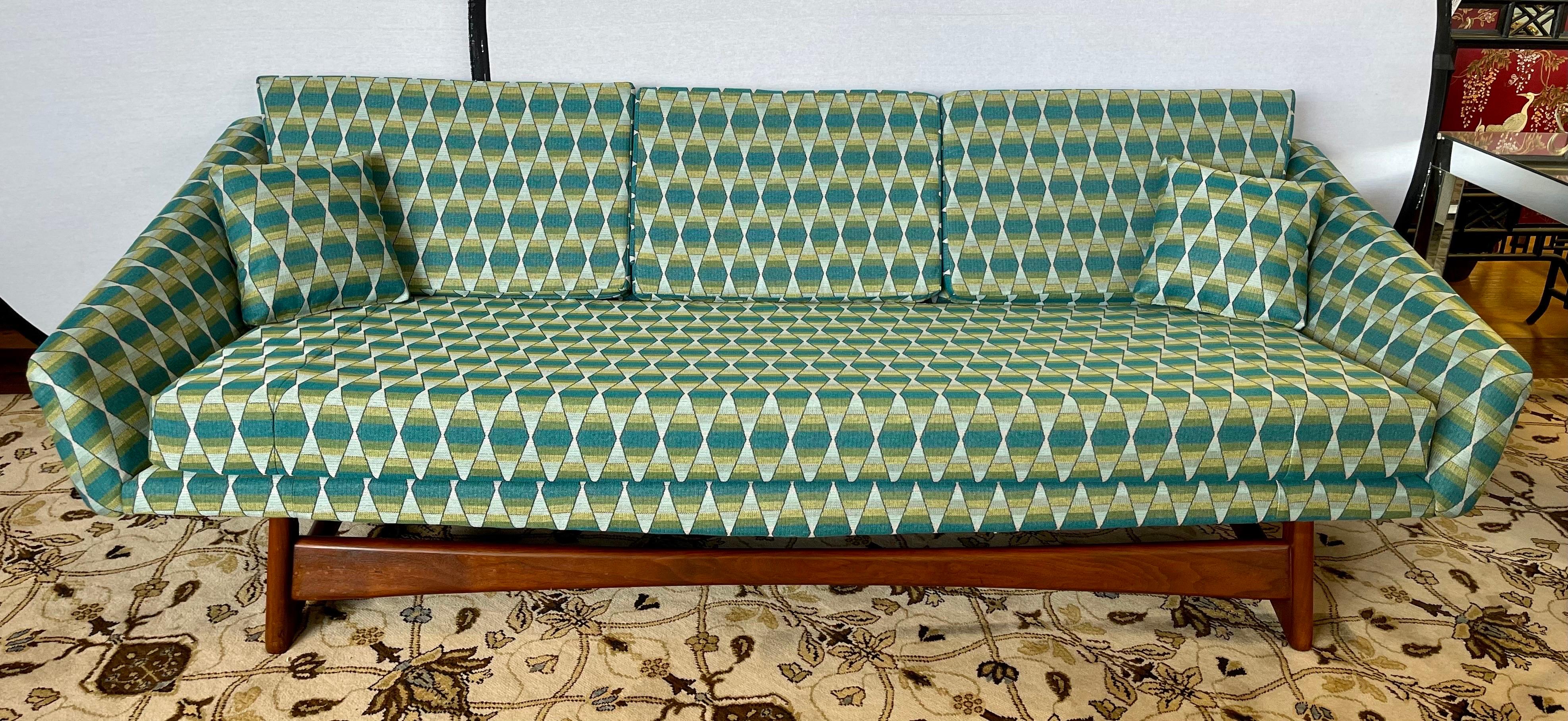 Authentic Adrian Pearsall pieces are some of his most dramatic creations. This one was just reupholstered and re-cushioned with rare Jack Lenor Larsen fabric.
The atomic design on the fabric is drop dead gorgeous with colors of gray, olive green,