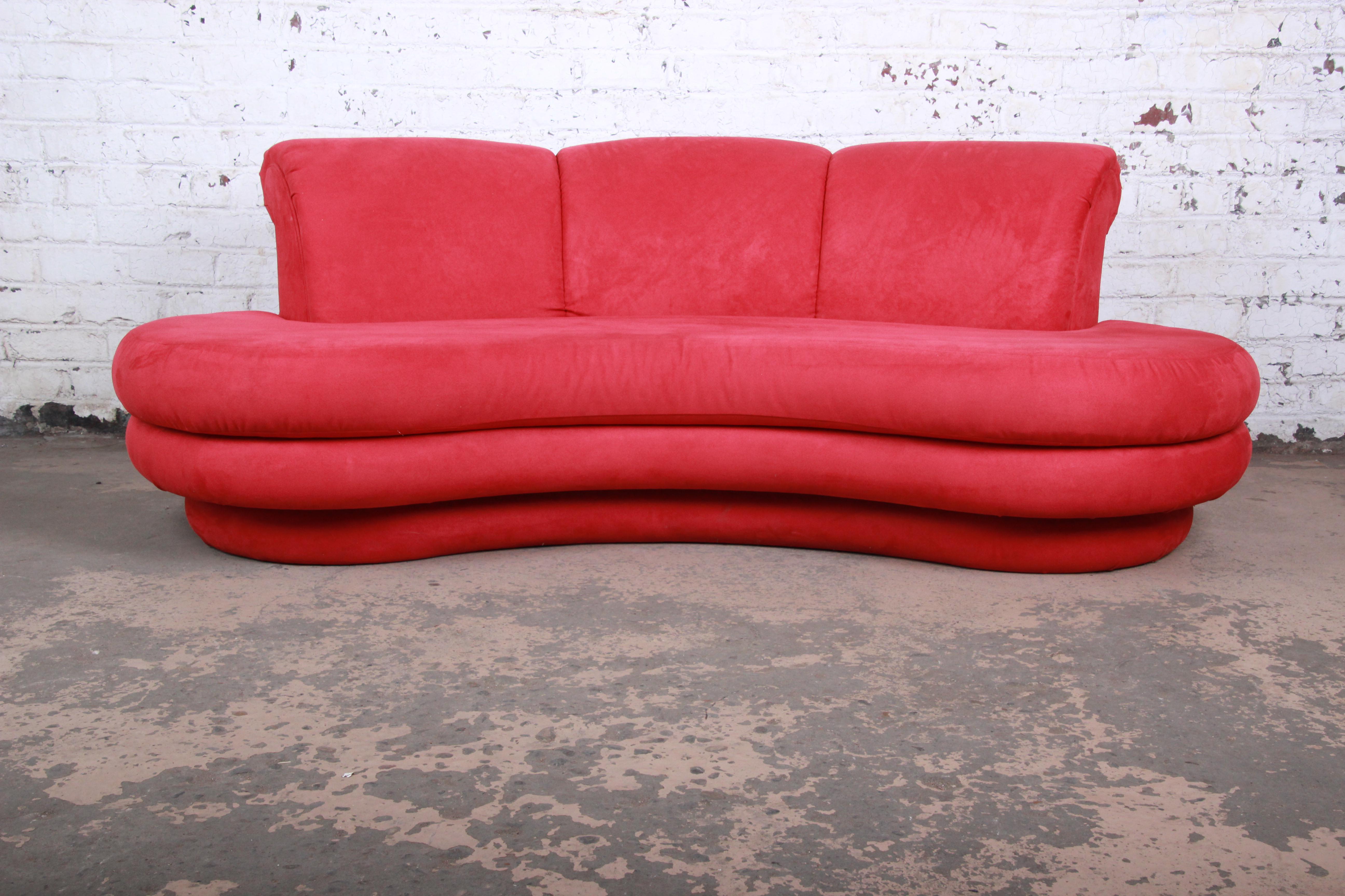 A gorgeous curved cloud sofa designed by Adrian Pearsall for Comfort Designs. The sofa features vibrant red upholstery and a unique organic three-tiered sculptural design. Very reminiscent in style to similar sofas designed by Milo Baughman or