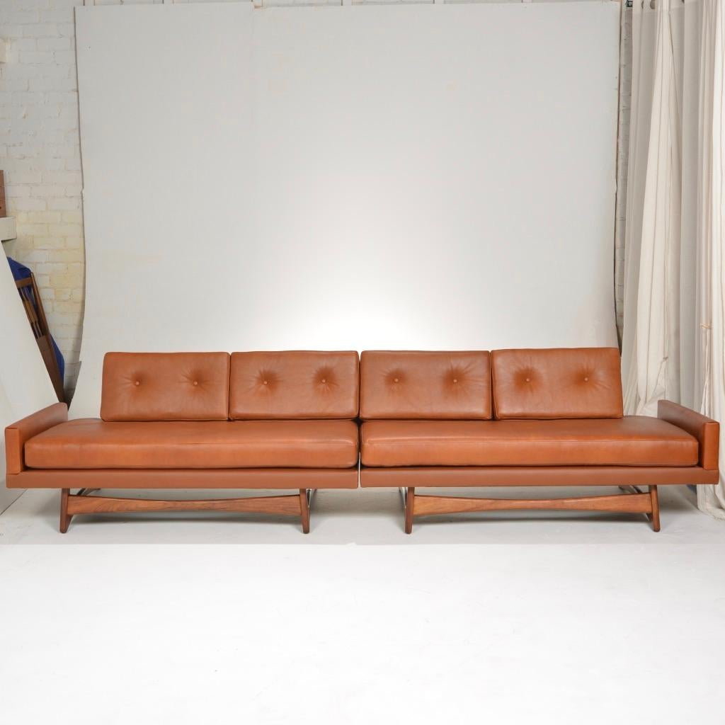 Beautiful long, low, and deep, brown leather floating back sofa by Adrian Pearsall. This sofa has been newly reupholstered in high quality soft brown leather and sits on an organic sculptural walnut sled base.