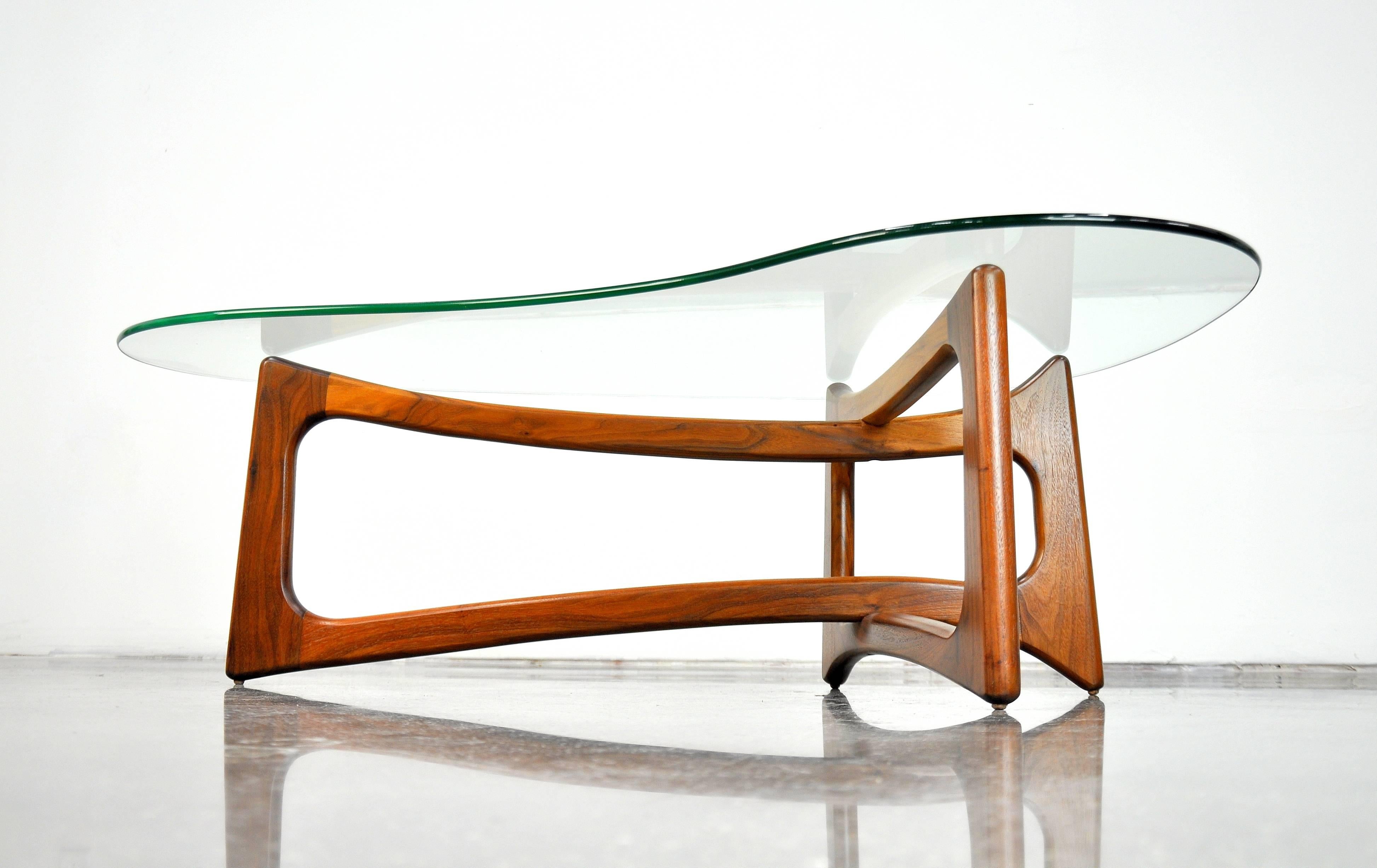 Beautiful Mid-Century Modern kidney shaped glass and sculptural walnut cocktail table, model 2450-TK, designed by Adrian Pearsall for Craft Associates, Inc. in the 1960s. The interlocking solid walnut base is topped by a biomorphic shaped glass. The