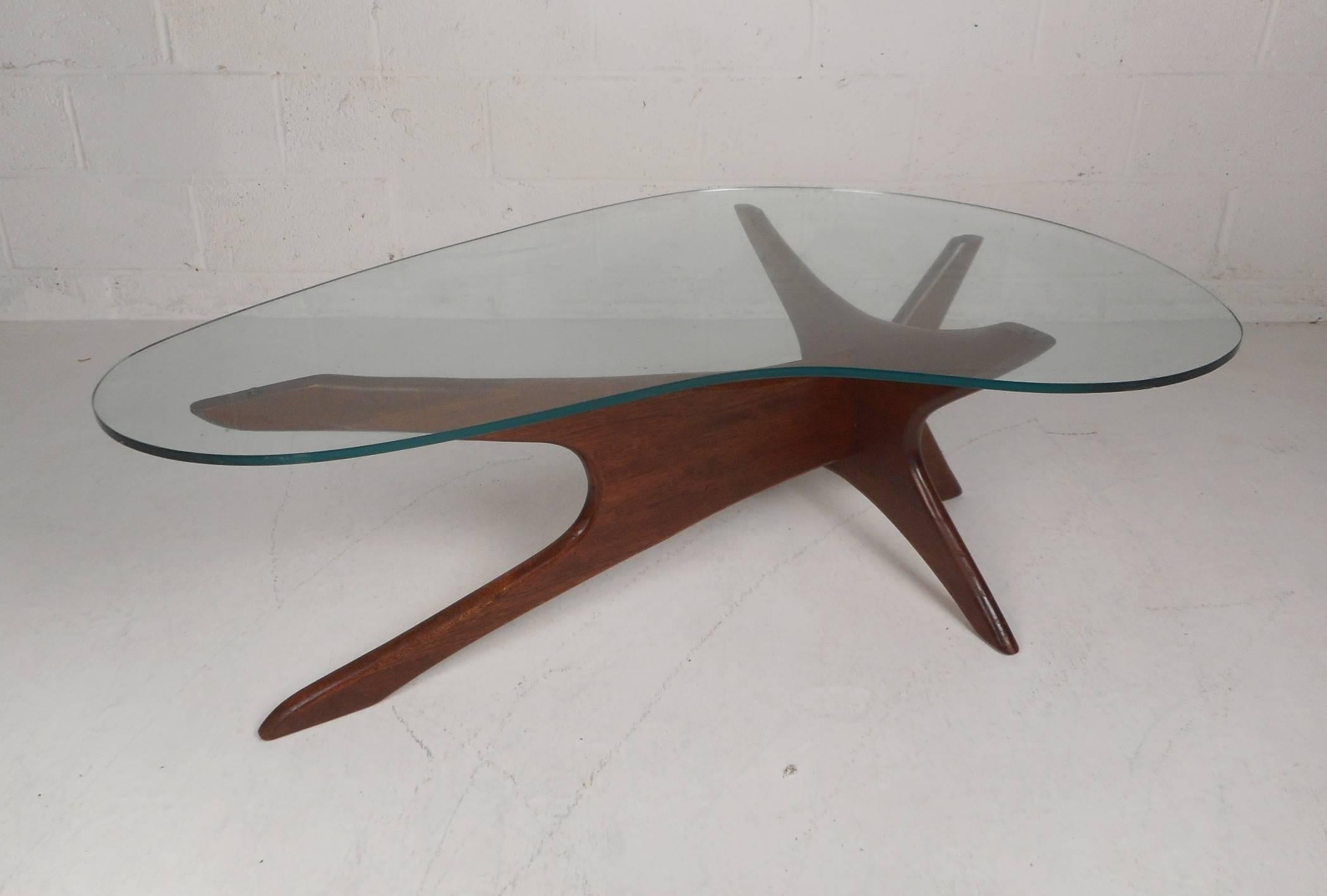 A stunning Mid-Century Modern amoeba shaped glass top coffee table by Adrian Pearsall. The unique walnut 