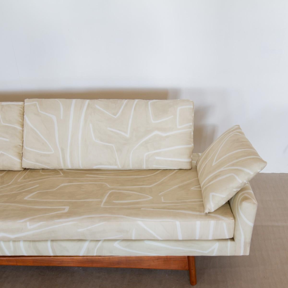 An Adrian Pearsall for Craft Associates, gondola sofa (model number 2408) with the iconic walnut base and upholstered by KBS in an ivory weave fabric, 1950s.