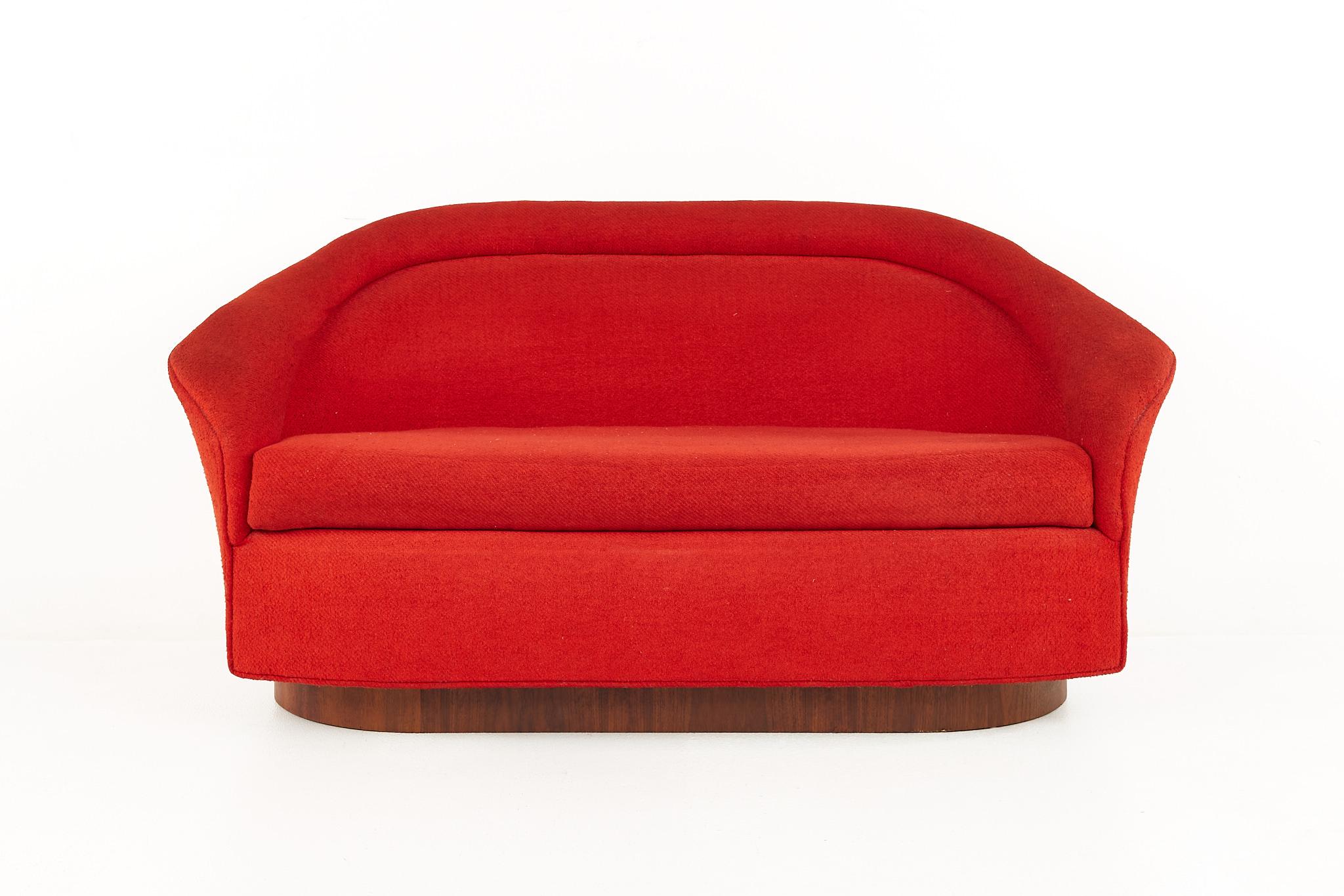 Adrian Pearsall for Craft Associatesmid century walnut plinth base red loveseat

This loveseat measures: 59.5 wide x 27 deep x 29.5 inches high, with an arm height of 25 inches

All pieces of furniture can be had in what we call restored vintage