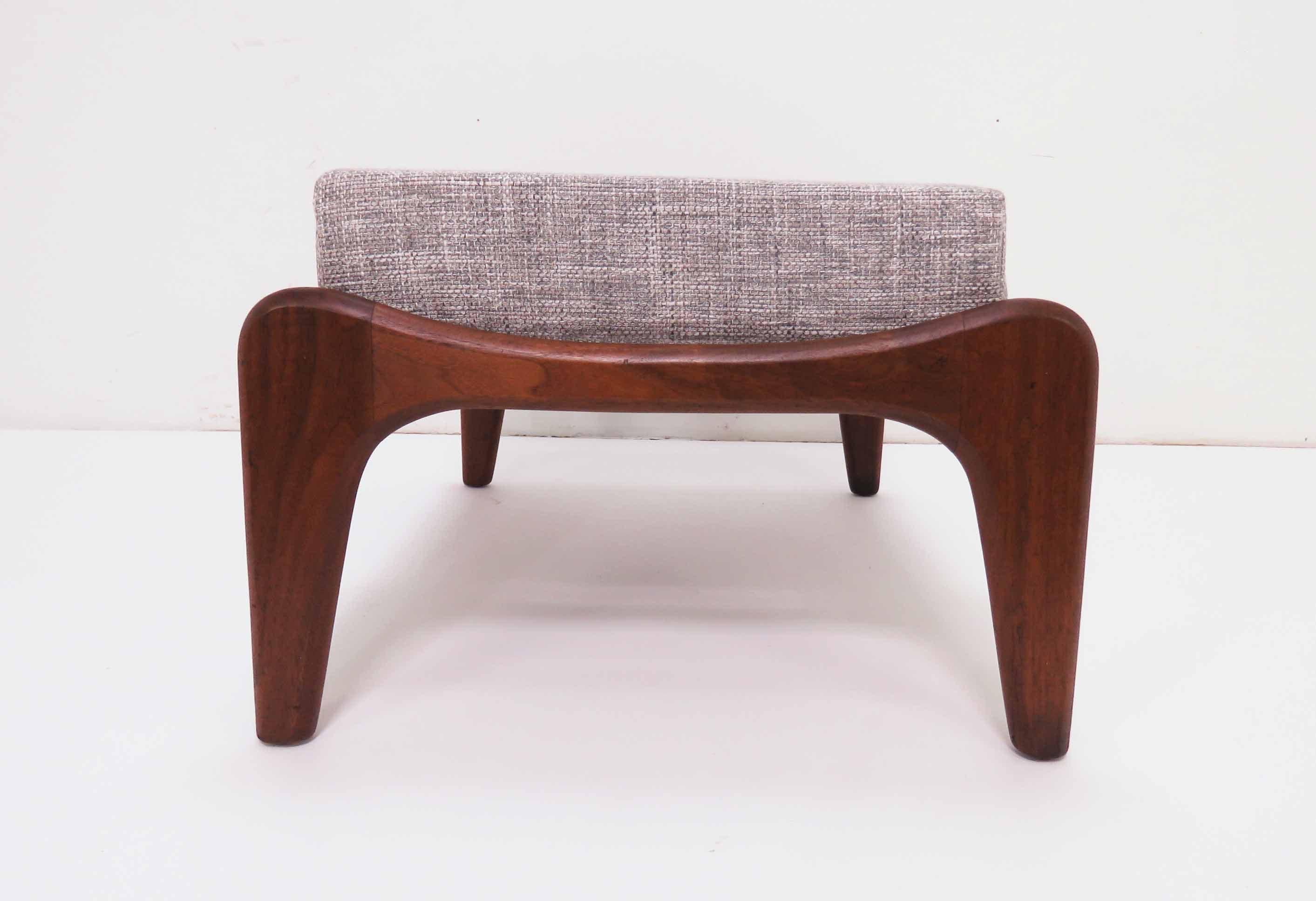Mid-century ottoman or foot stool in walnut, with newly replaced webbing and seat cushion, by Adrian Pearsall for Craft Associates, circa 1960s. Matches many different Pearsall lounge chair models, or attractive on its own.