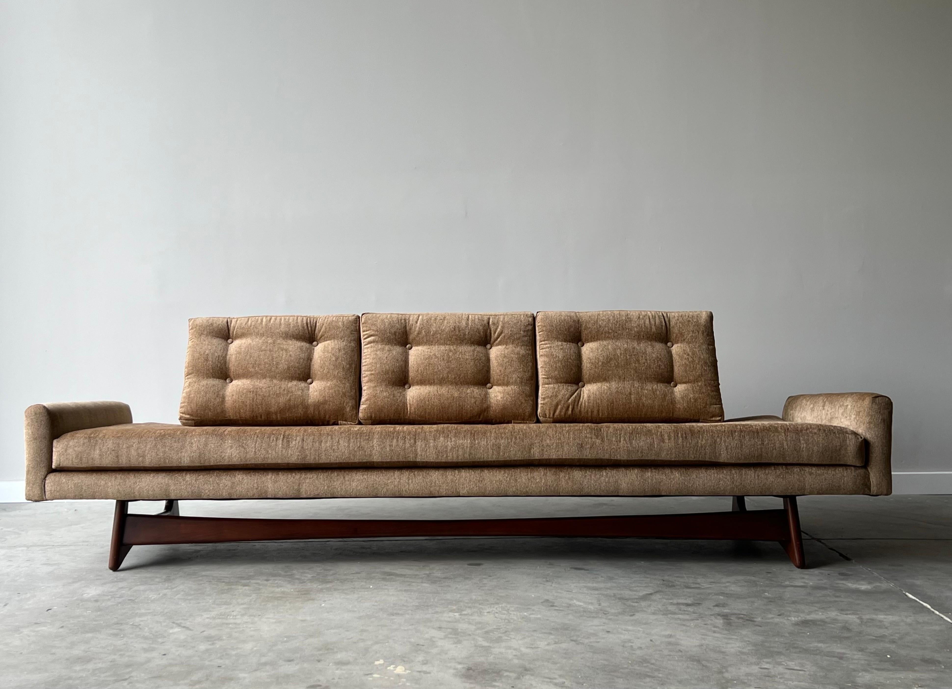 Mid-century sofa designed by Adrian Pearsall for Craft Associates. This 2408-S model sofa or often referred to as the “gondola sofa” was made circa 1950s. The sculpted walnut base steals the show along with the newly upholstered fabric. Color of the