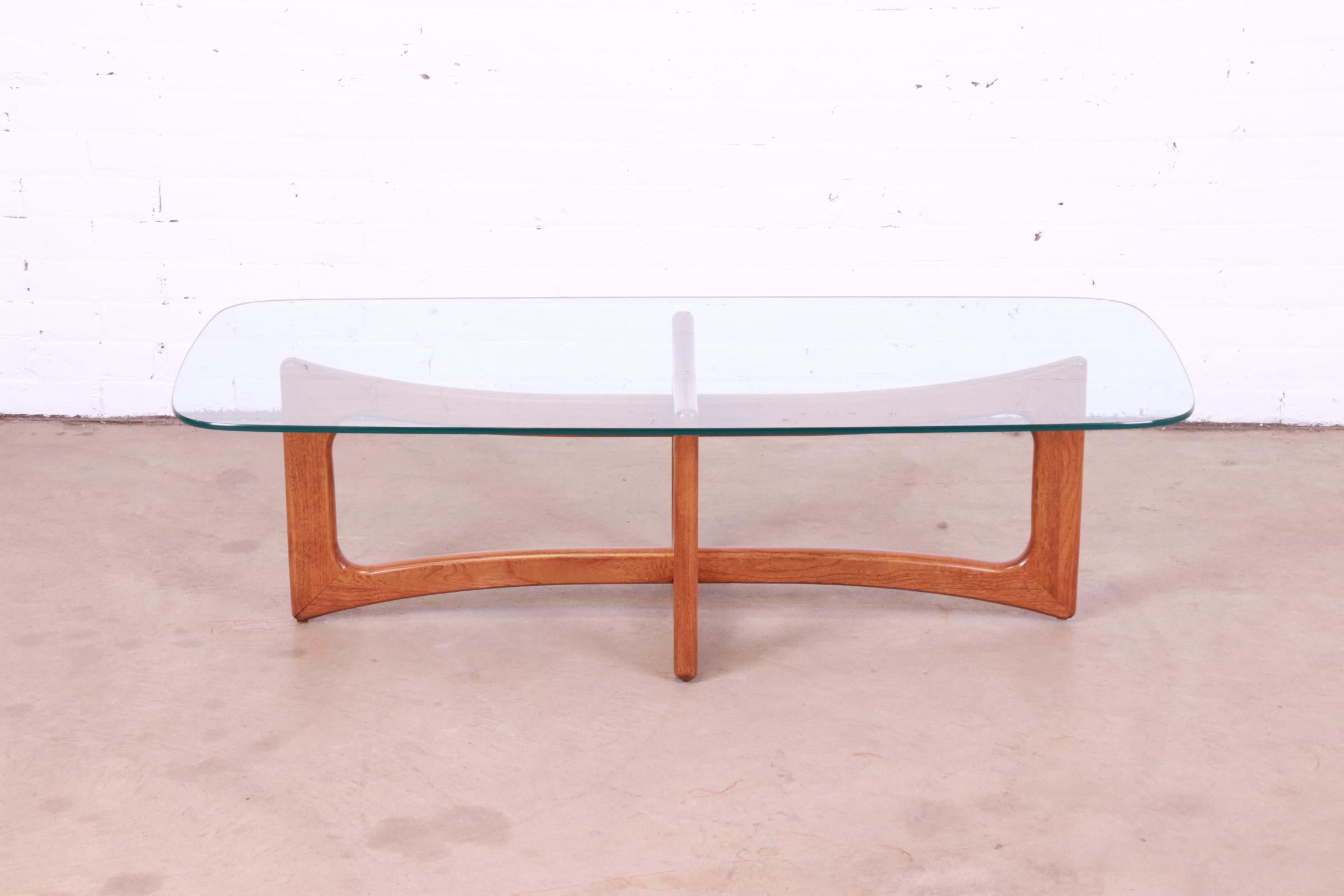 A gorgeous Mid-Century Modern ribbon coffee or cocktail table.

By Adrian Pearsall for Craft Associates.

USA, 1960s

Sculpted walnut base, with glass top.

Measures: 52