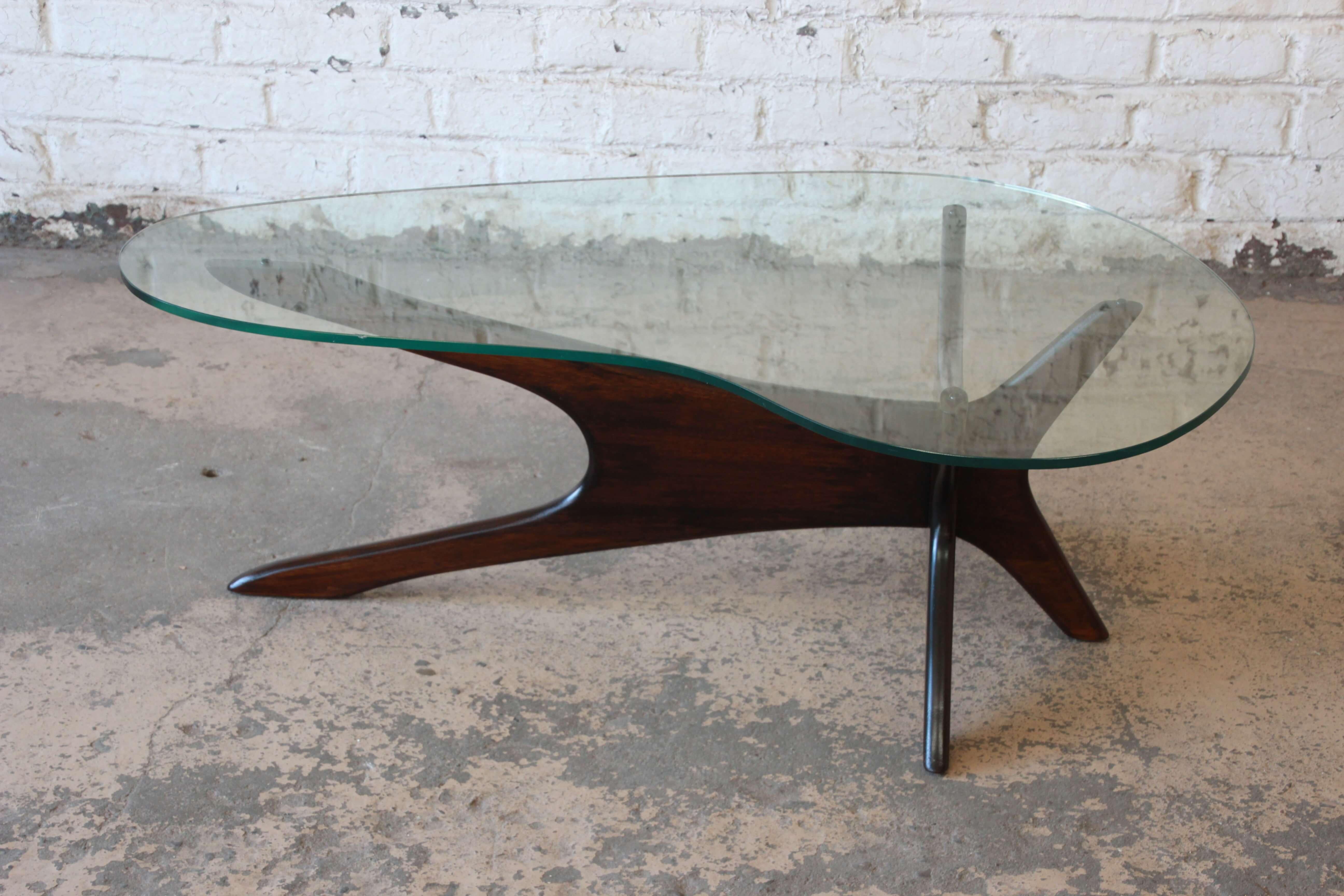 Offering a very nice dark walnut coffee table by Adrian Pearsall for Craft Associates. The table has a unique asymmetrical design with a curved glass top. This elegant modern design displays the foundation of many of Pearsall's designs. This table