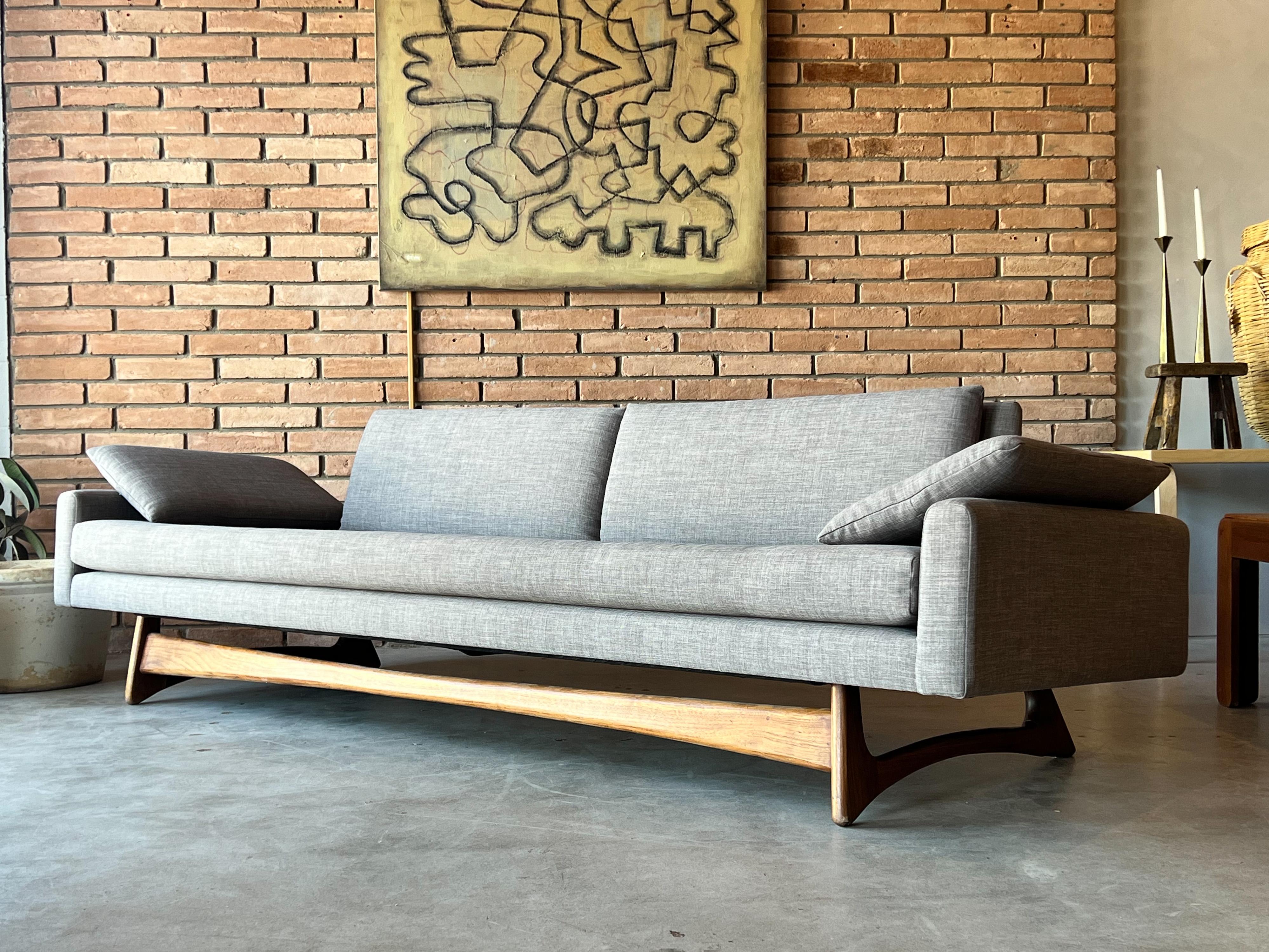 Beautiful sofa designed by Adrian Pearsall for Craft Associates, c. 1960s. Model 2408 shows off its sculptural solid walnut base from every angle and is no wonder it’s as iconic as mid-century sofas get. It is often imitated. Not only is this sofa