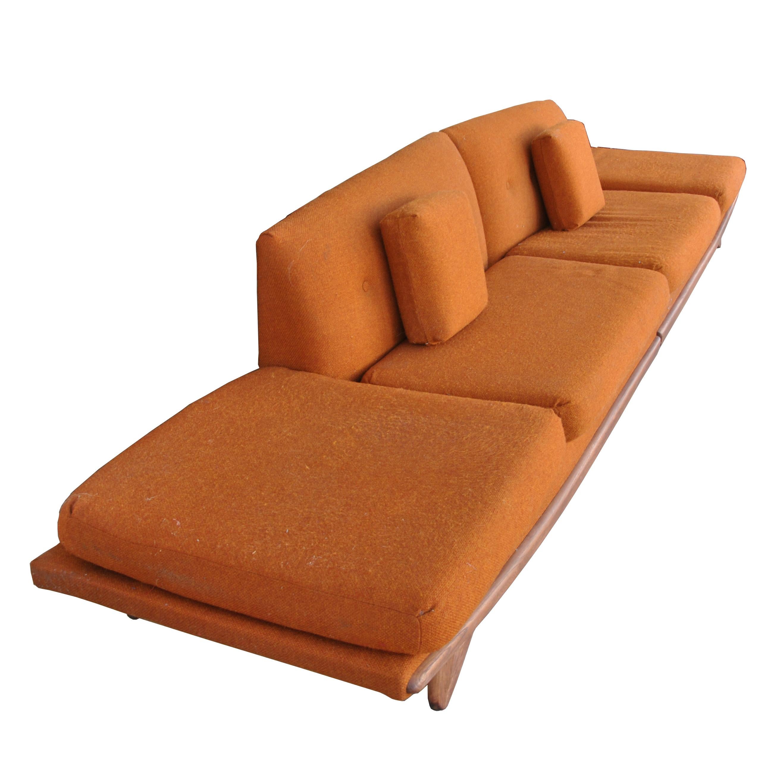 A mid-century modern sectional sofa designed by Adrian Pearsall and made by Craft Associates.  Two 6ft sections that can be positioned end to end for a long sofa or used as two separate sofas.  Sculpted walnut base with orange tweed upholstery. 