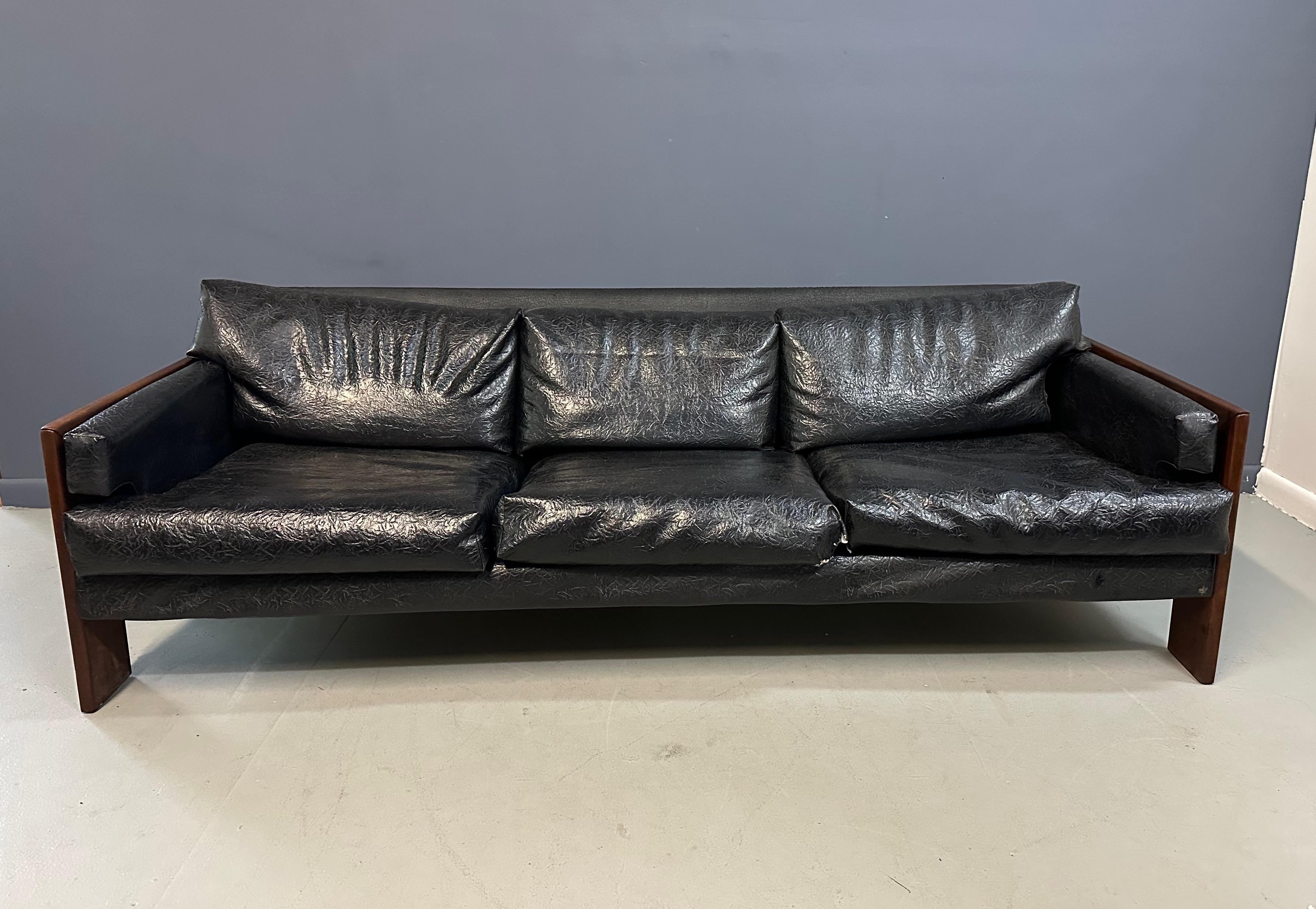 Expertly designed by Adrian Pearsall and produced by Craft Associates, this mid-century sofa features walnut trimmings that add a touch of elegance and sophistication to any living space. The smooth lines and high-quality materials make for a very