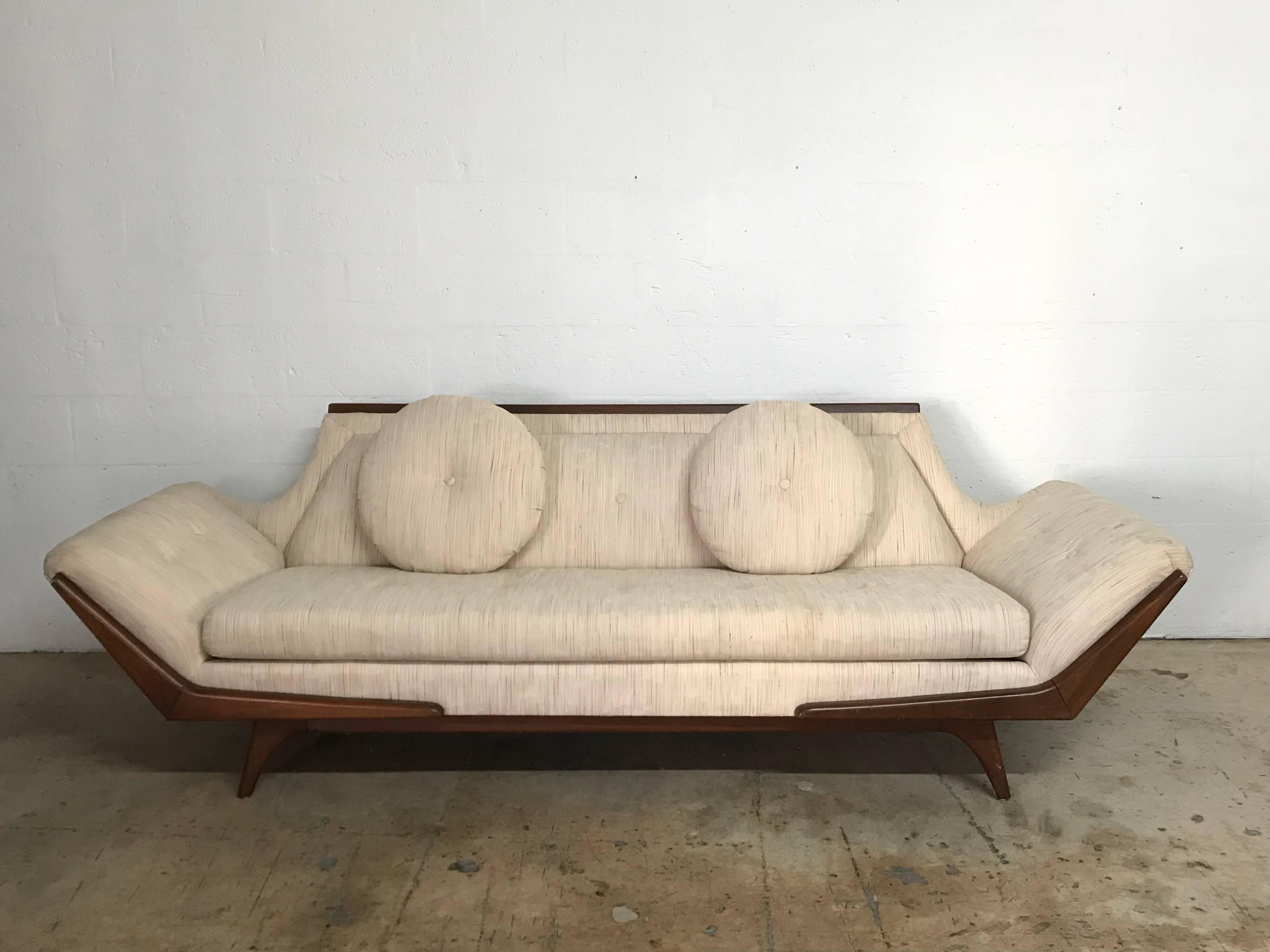 Gondola sofa designed by Adrian Pearsall for Craft Associates, rendered in walnut with original woven upholstery and matching round throw pillows.