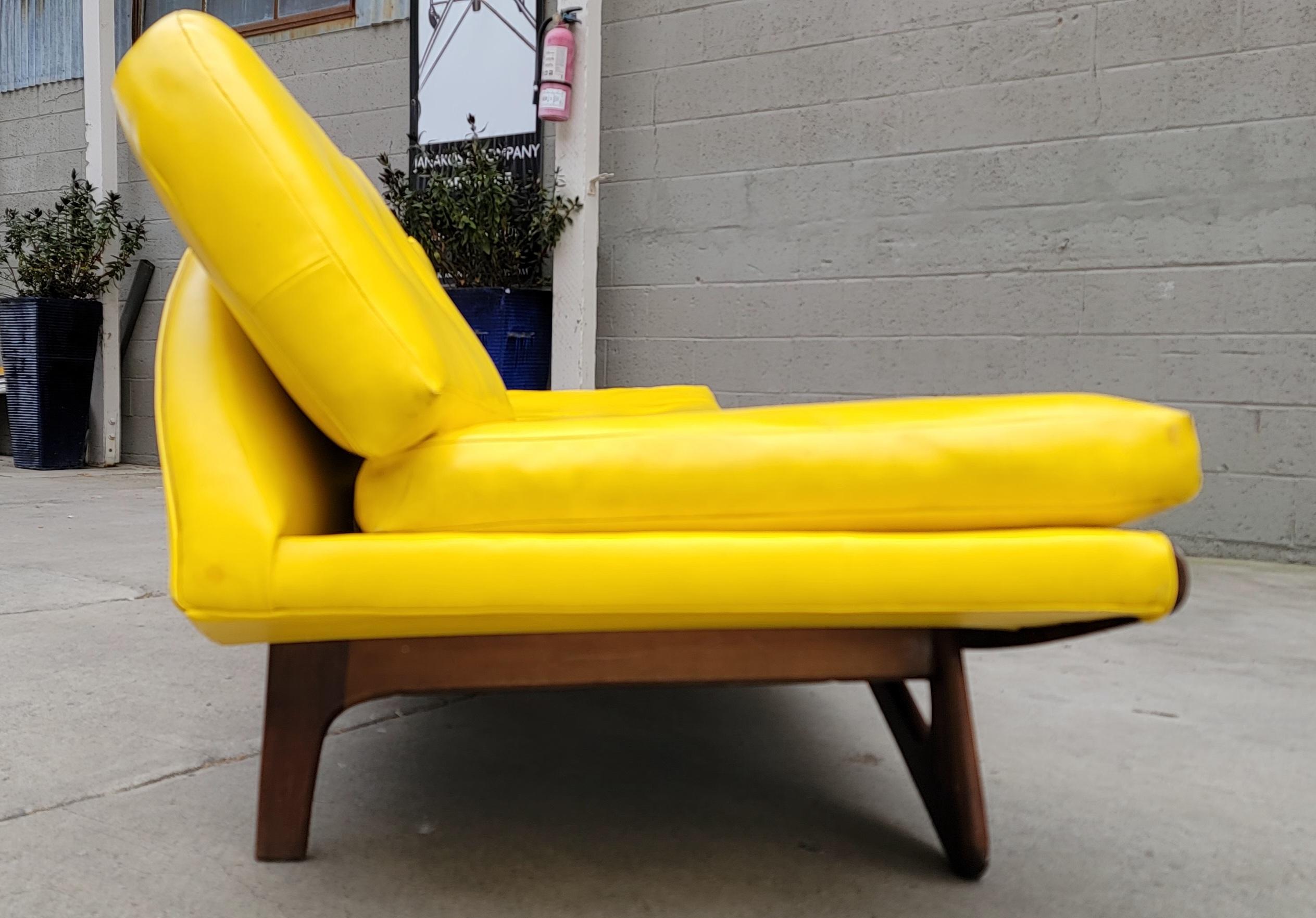Authentic Adrian Pearsall for Craft Associates Gondola sofa. Circa. 1950's. Solid walnut frame in fine original condition with original finish. Very sturdy. Iconic Mid-Century Modern design. Older re-upholstery in yellow vinyl is worn, new