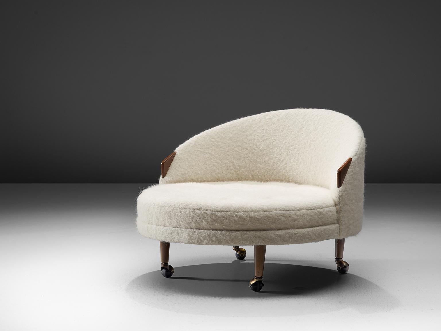 Adrian Pearsall for Craft Associates, 'Havana' lounge chair, walnut and Pierre Frey woollen upholstery with walnut, United States, 1960s.

This lounge chair with small walnut armrests and wheels underneath each item, are designed by Adrian