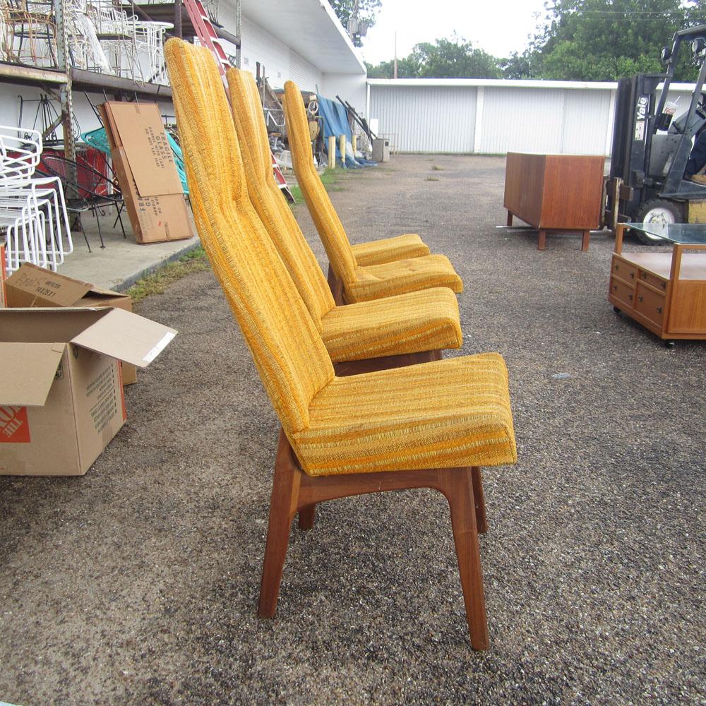 A set of four vintage Mid Century Modern hig back dining chairs by Adrian Pearsall for Craft Associates. Chairs feature lovely sculptural seats over solid walnut bases and original, yellow striped upholstery. These interesting chairs would look