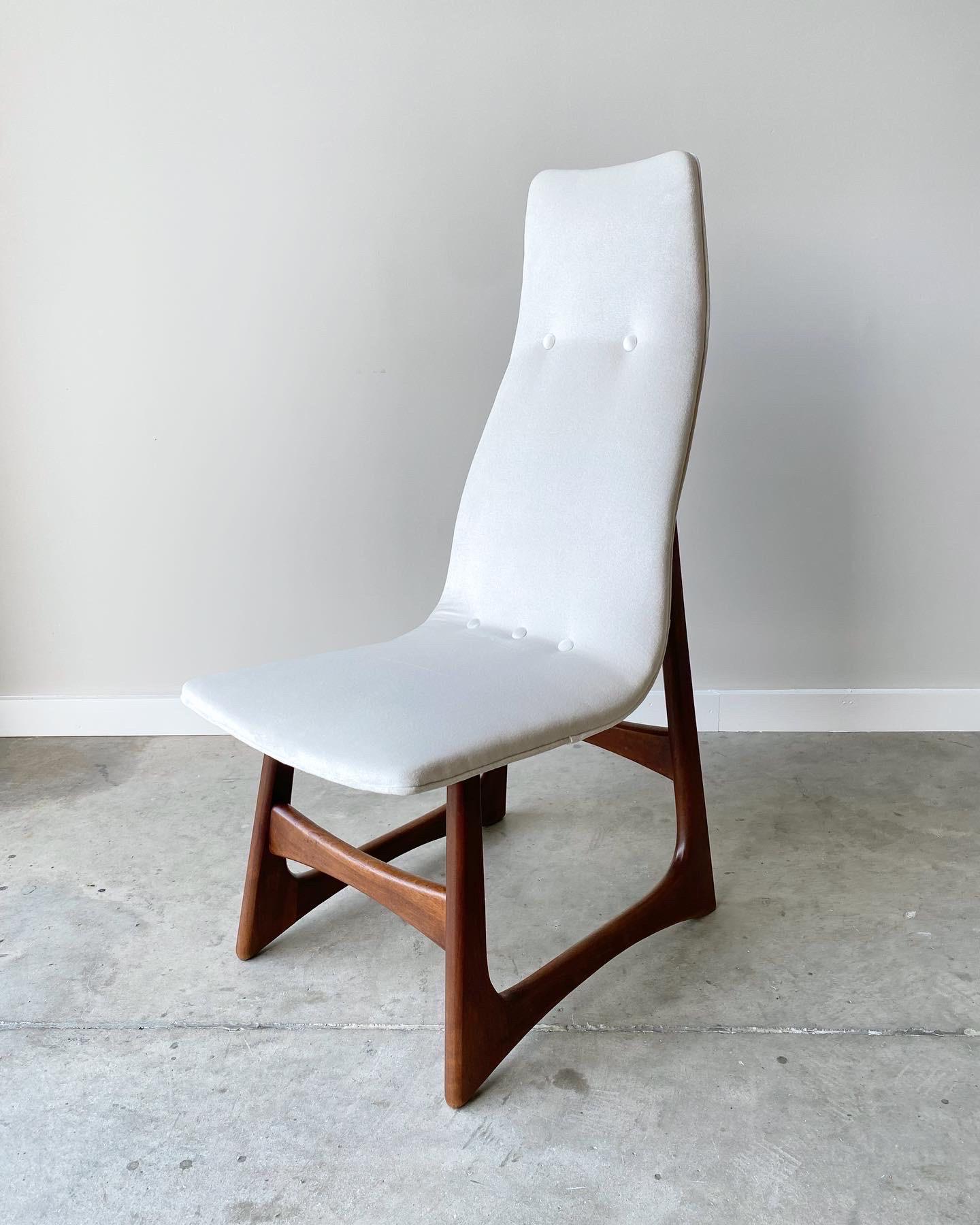 A stunning and rare setoff dining chairs from Adrian Pearsall.  Sculpted walnut frames with sled base, newly refinished.  New ivory velvet to the high back seats.  A very uncommon form and complete set of six, fully restored. 