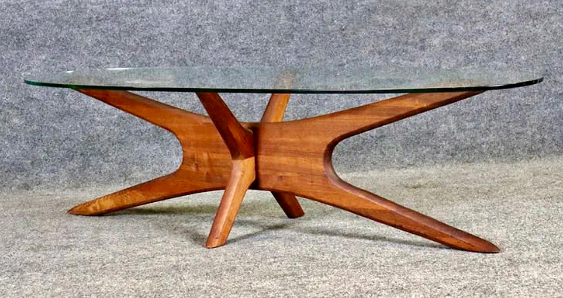 Surfboard shaped coffee table designed by Adrian Pearsall. Featuring a starburst interlocking walnut base with oval glass top. Simple design with a great mid-century flair.
Please confirm location NY or NJ