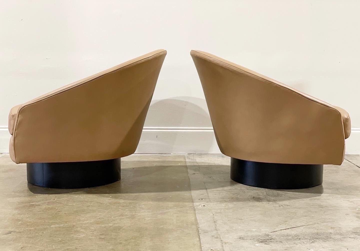 Exquisite pair of rare leather Adrian Pearsall for Craft Associates swivel and rocking barrel lounge chairs on 6 inch ebonized plinth bases. This set is unique on the market currently. Complete restoration by our team of in-house craftspeople - all