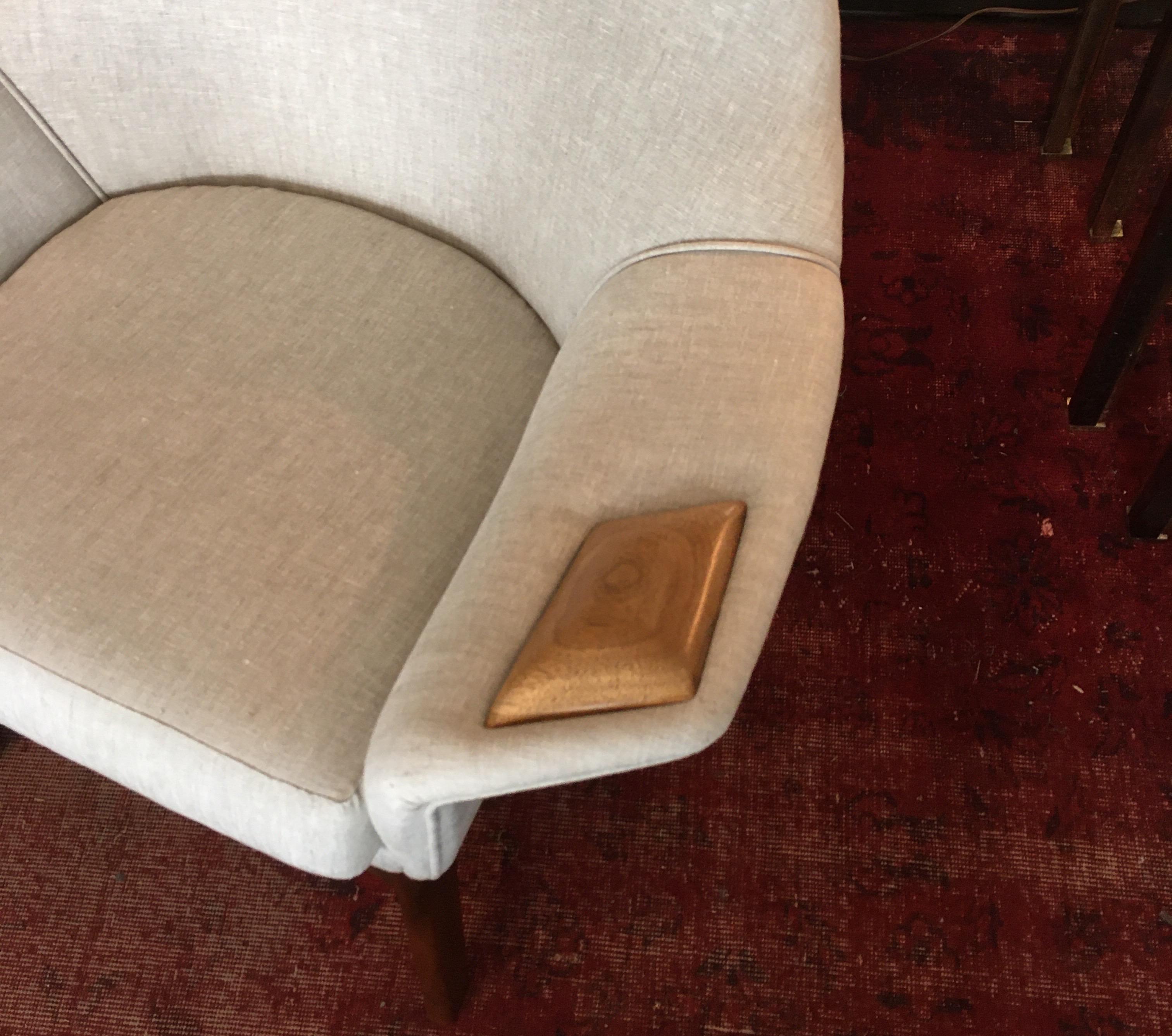 Sculptural midcentury lounge chair professionally reupholstered in linen, with wood inset arms. Very handsome from every angle and very comfortable.