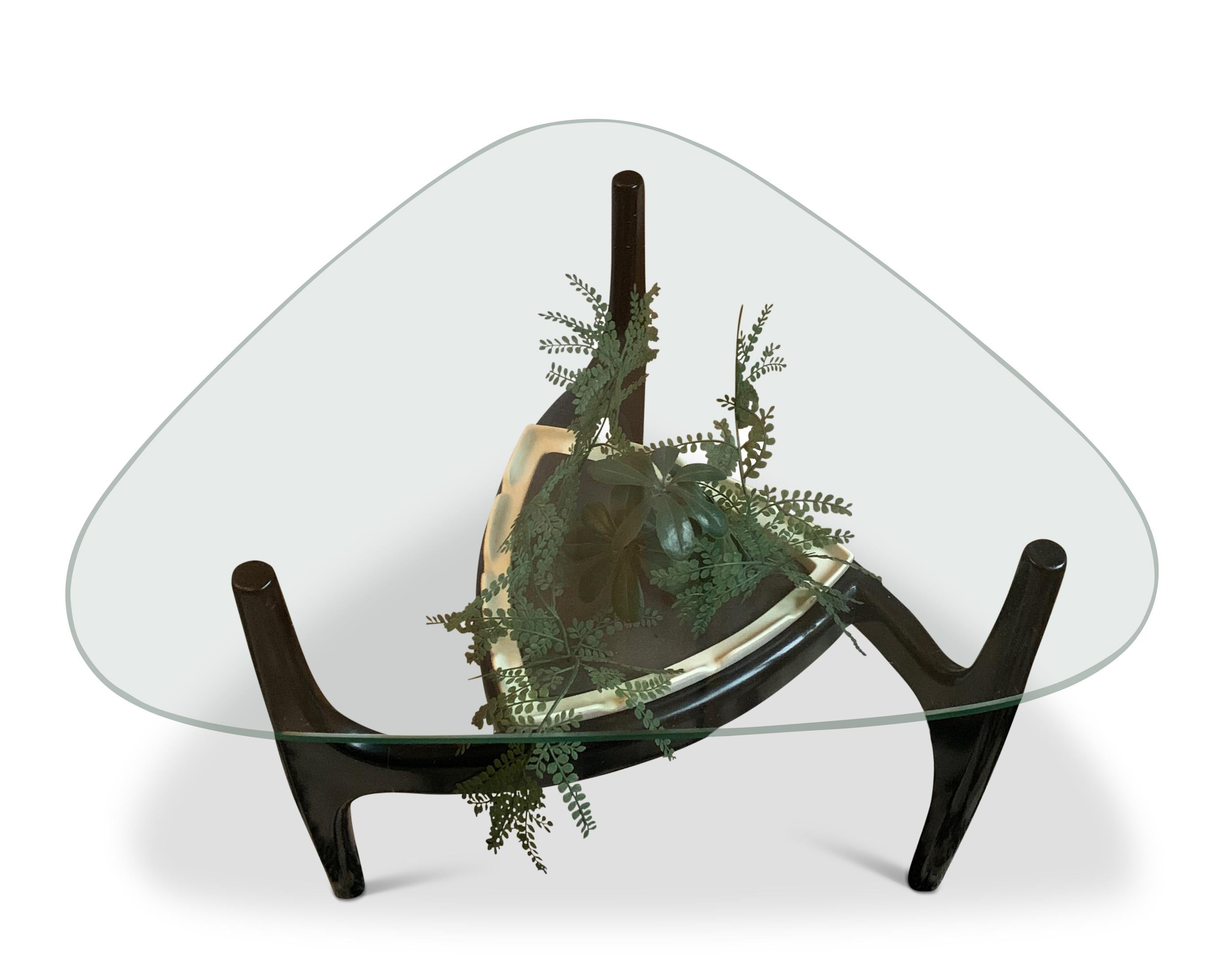 Adrian Pearsall midcentury amorphic glazed triform ebonised coffee table with tonk ceramic insert by Royal Haeger Made in the USA

Table features an amorphic, clear glass top panel sitting on a walnut frame. The frame features a curvilinear design