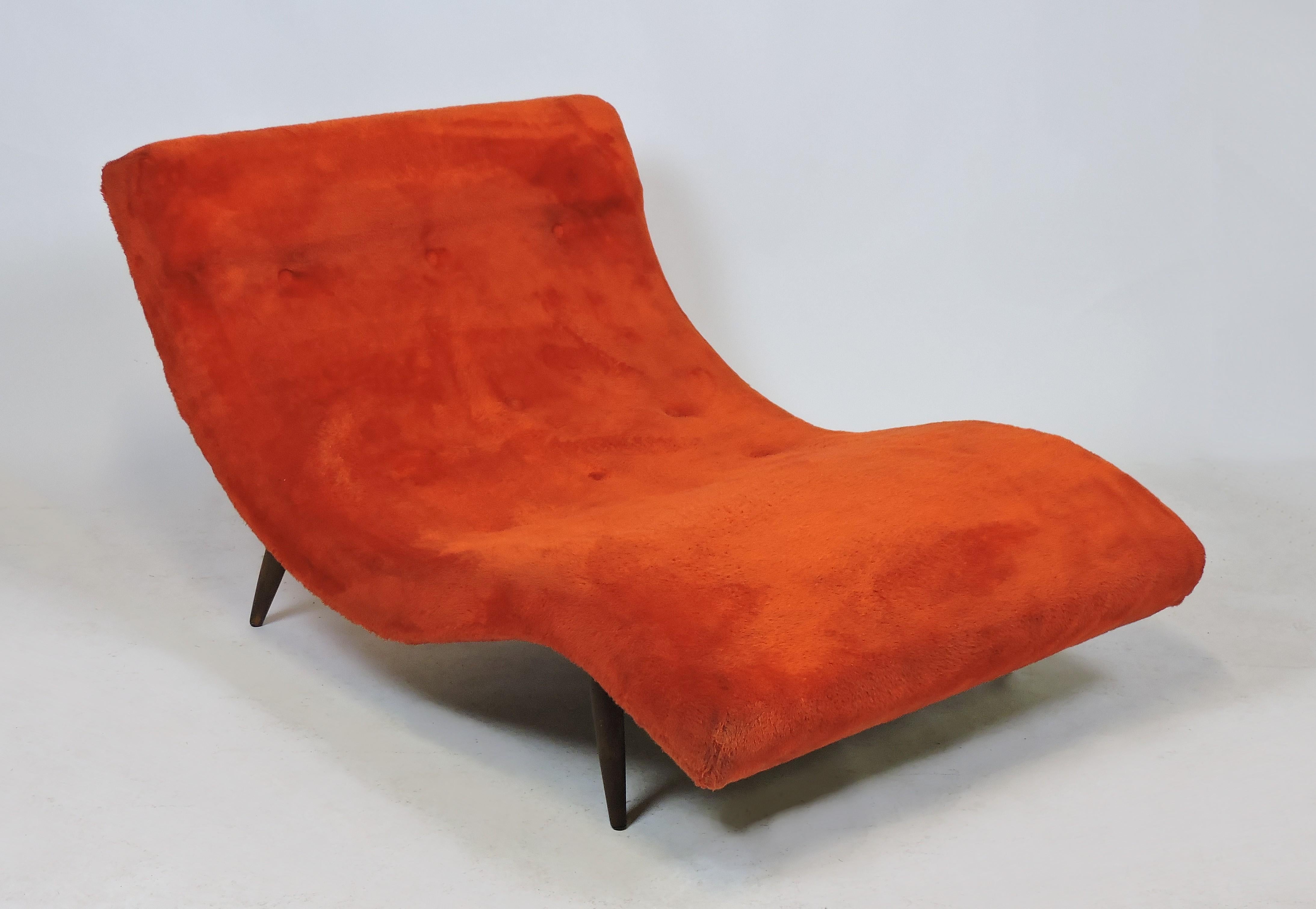 Very comfortable and iconic wave lounge chair, model 108-C, designed by Adrian Pearsall and made by Craft Associates. This chair has a curvy sculptural form with tapered walnut legs and the original orange shag upholstery. Can comfortably seat two.