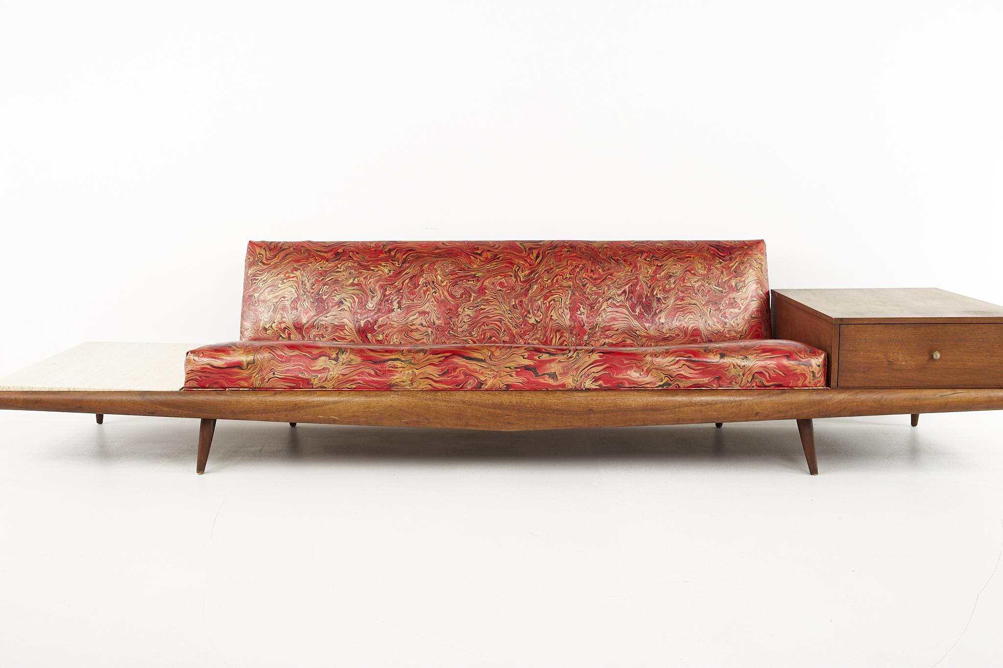 Adrian Pearsall mid century travertine and walnut platform sofa

The sofa measures: 125 wide x 30 deep x 27 high, with a seat height of 15 inches

All pieces of furniture can be had in what we call restored vintage condition. That means the