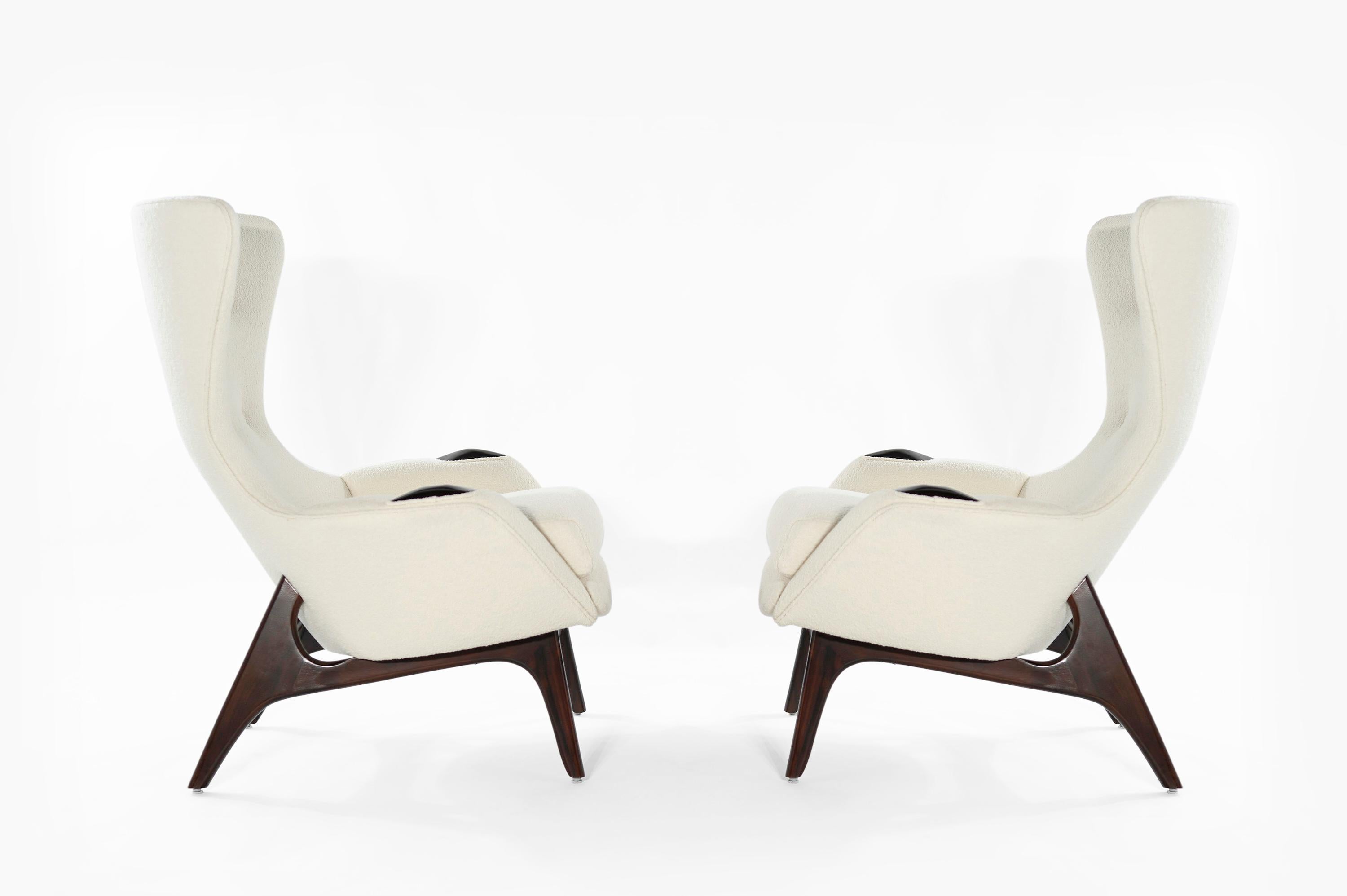 Rarely seen set of lounge chairs designed by Adrian Pearsall for Craft Associates, circa 1950s. Sculptural walnut bases and armrest detail have been redone in espresso finish, complimenting the off-white bouclé perfectly. Priced as a set. Fabric