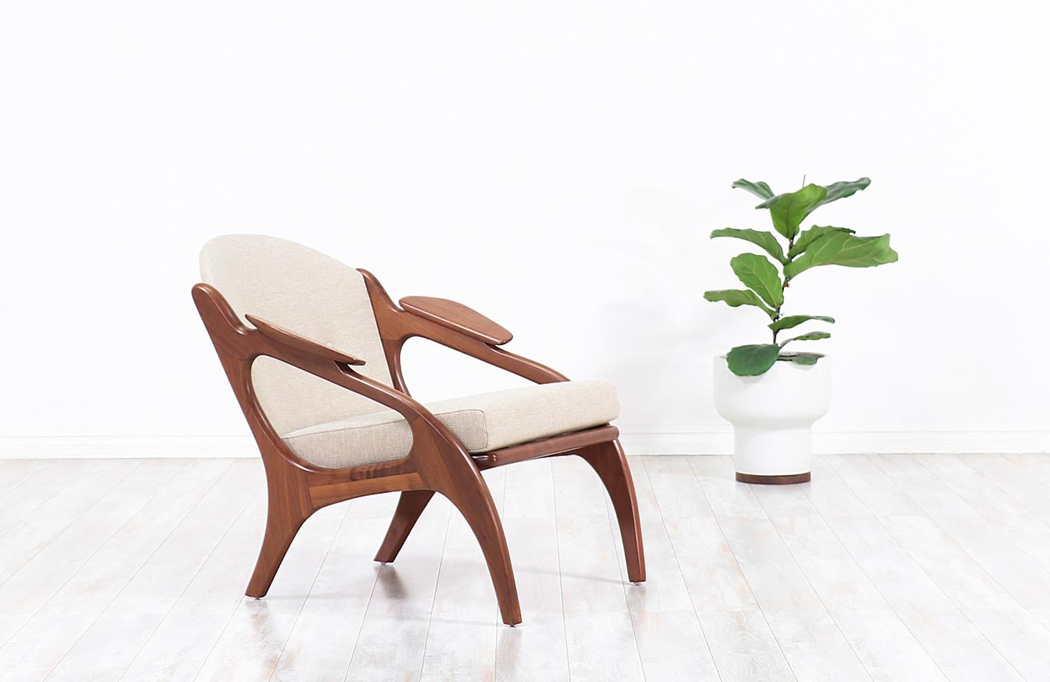 Stylish Mid-Century Modern lounge chair Model 2249-C designed by Adrian Pearsall for Craft Associates in the United States, circa 1960s. This elegant and ergonomic lounge chair features a solid walnut angled base and sculpted wood padded arms
