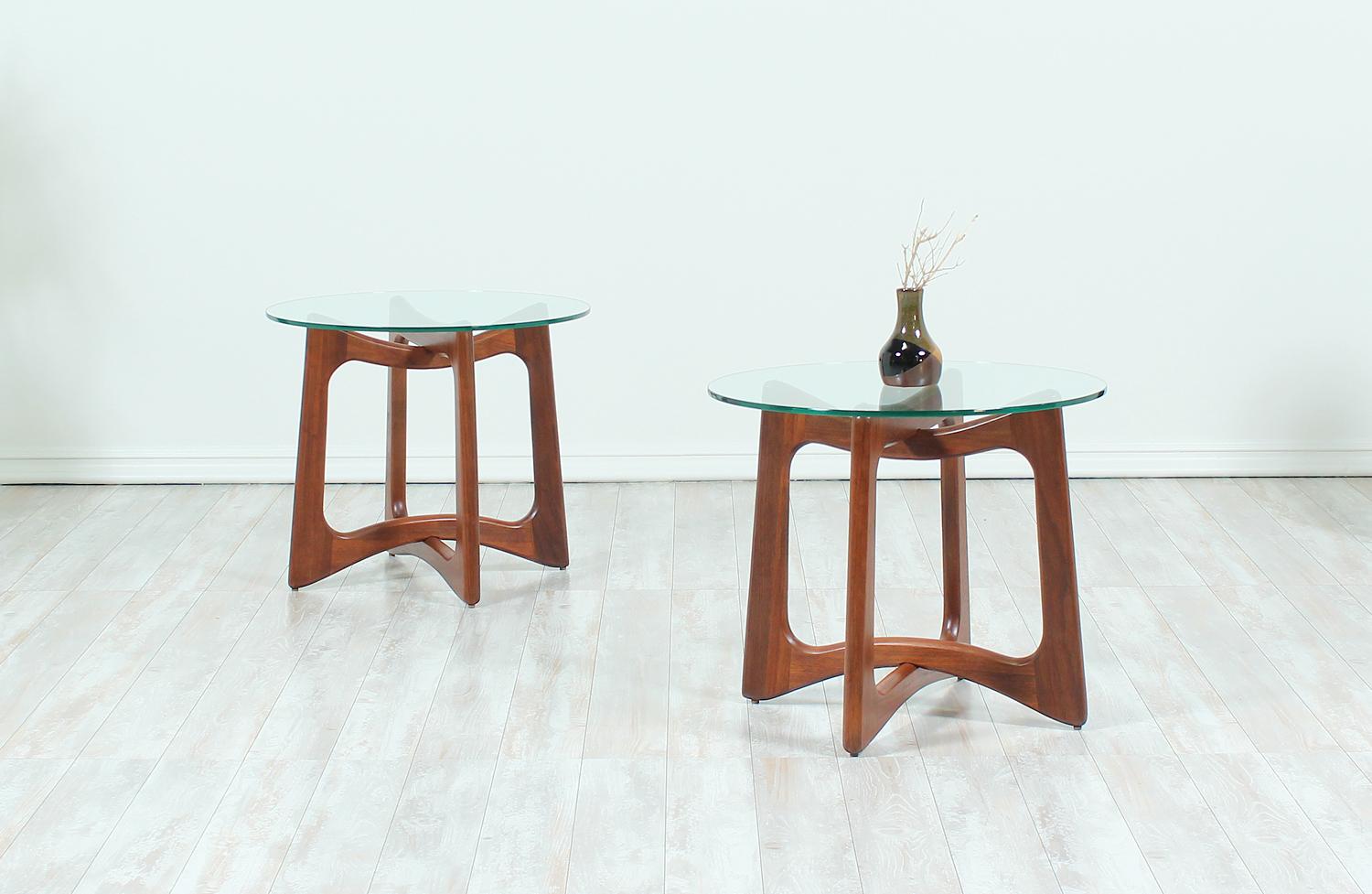 A pair of 2460-T24 side tables designed by Adrian Pearsall for Crafts Associates in the United States circa 1960s. These beautiful side tables feature an interlocked walnut wood base showing exceptional craftsmanship visible through the new glass