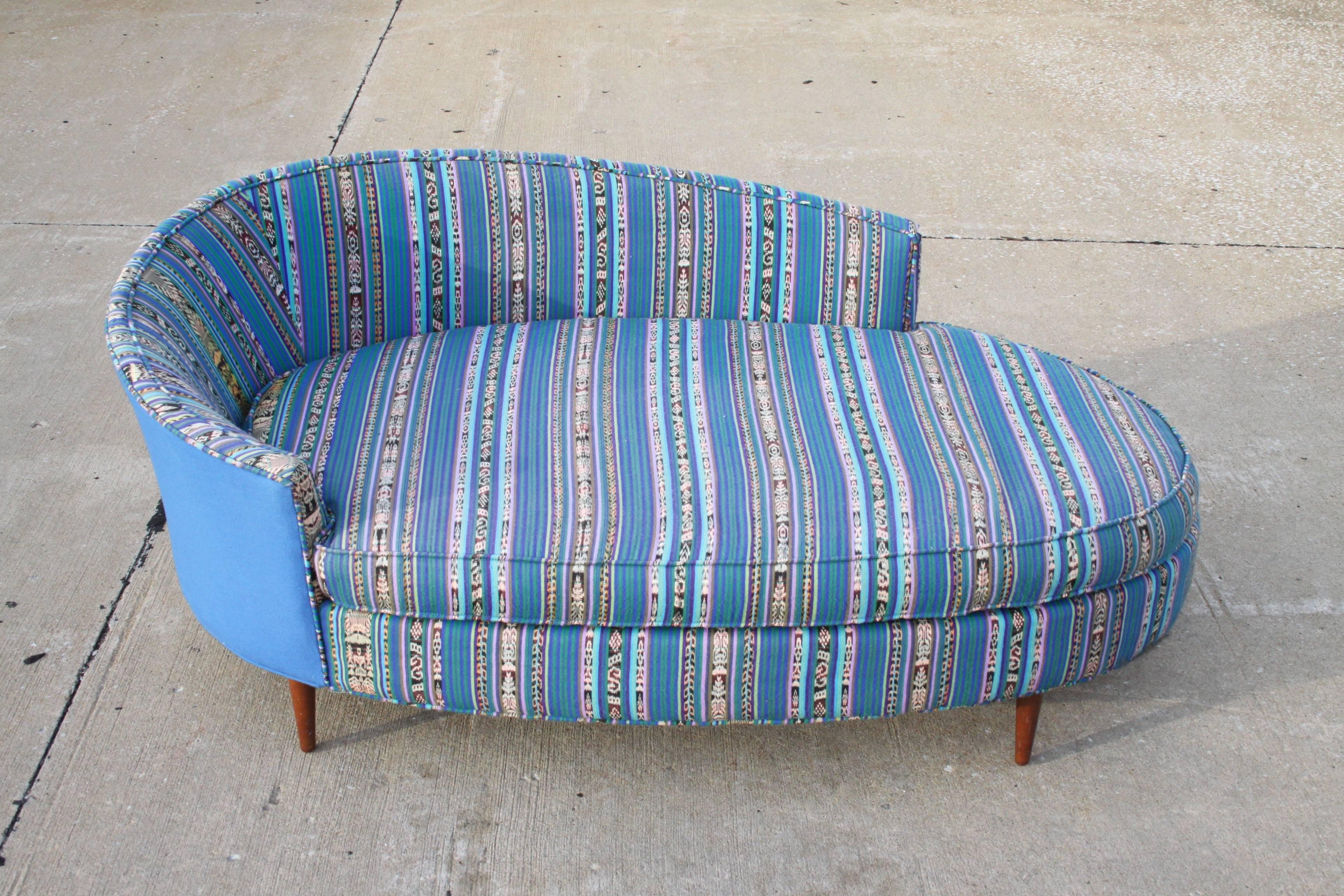 Mid-Century Modern Adrian Pearsall for Craft Associates oval chaise longue or sofa upholstered with Mexican striped textile and solid blue cotton, circa 1960s. Fabric is vintage, shows some fading, foam is good. Low partial back, tapered walnut legs.