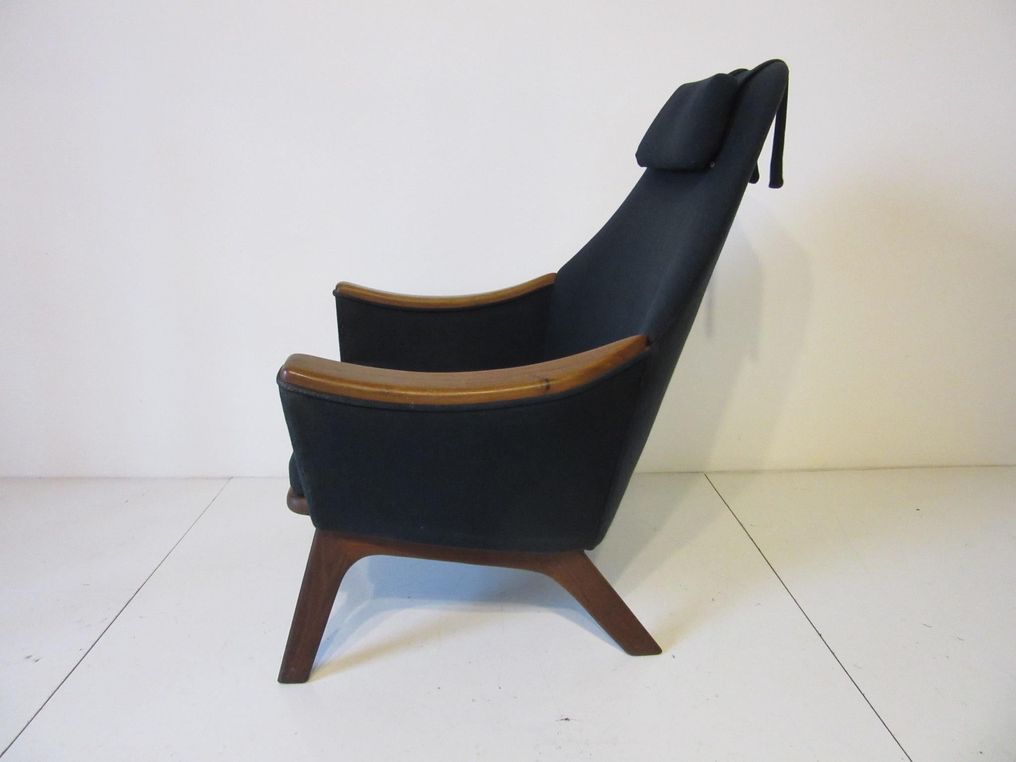 Adrian Pearsall Papa Bear styled lounge chair with solid walnut base and accent arm pads upholstered in a black woven fabric with adjustable head pillow and additional back pillow, manufactured by Craft Associates.