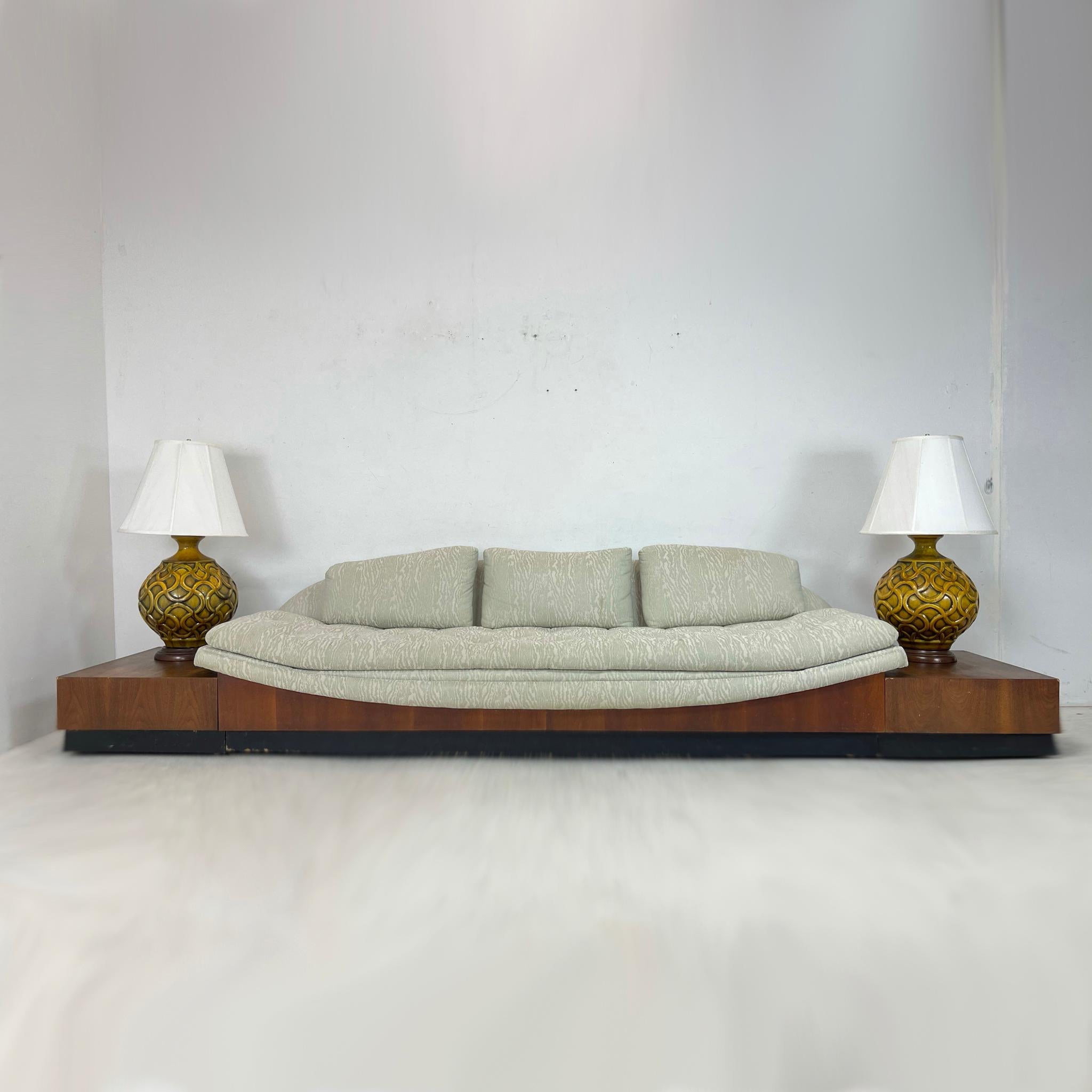 Fantastic Adrian Pearsall Platform Gondola sofa with adjoining side tables. The sofa has an upholstered hammock-curved seat that sits atop a walnut platform base with black plinth. Includes removable walnut platform side tables. The sofa is sturdy